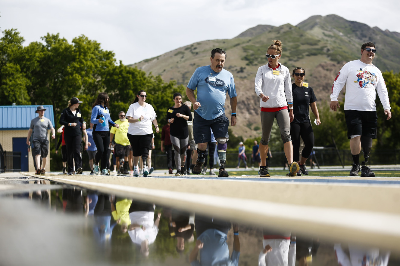 Attendees of the fourth annual Utah Adaptive Mobility Clinic work with physical therapists as they walk around the track at Skyline High School in Salt Lake City on Saturday, June 1, 2019. The event, for or people with lower extremity limb loss or limb difference, has doubled in size since last year and is put on by Hanger Clinic. (Photo: Silas Walker, KSL)