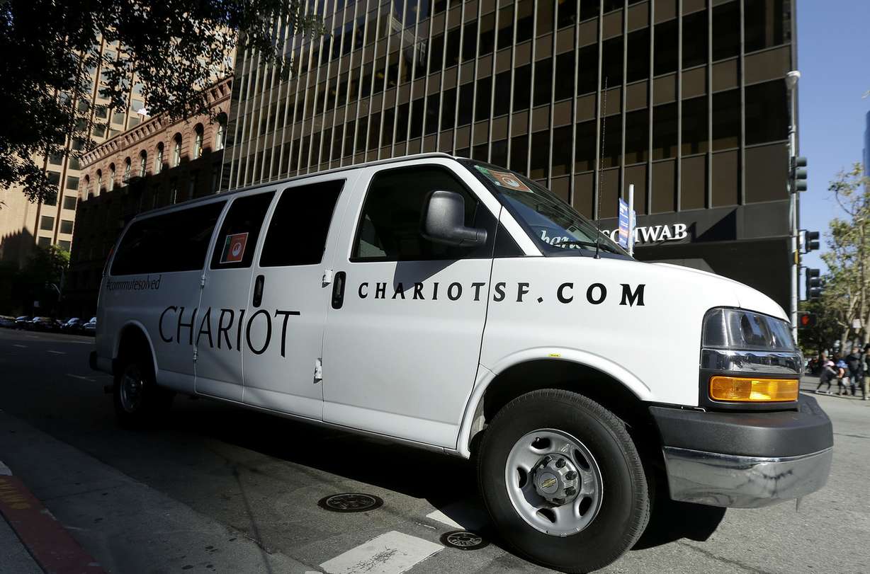 In this April 14, 2015, photo, a Chariot shuttle bus drives in San Francisco. A company called Leap, a bus company that offers rides with spacious seating, free Wi-Fi and attendants who deliver snacks, launched the service last month with morning and evening commutes that follow public bus routes between the tony Marina district and the heart of downtown San Francisco. (Photo: Jeff Chiu, Associated Press)