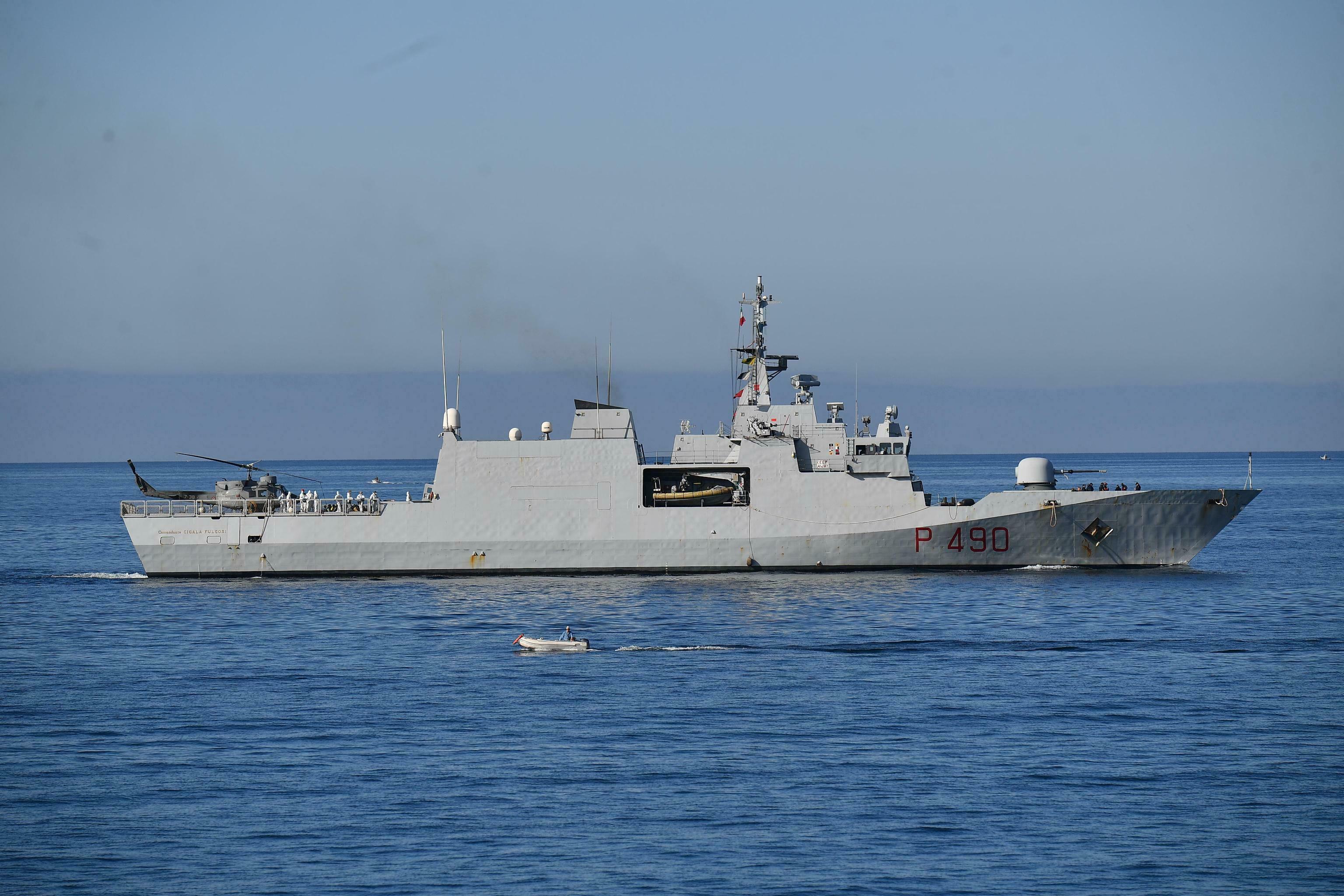 Italian navy ship with 100 rescued migrants docks in Genoa