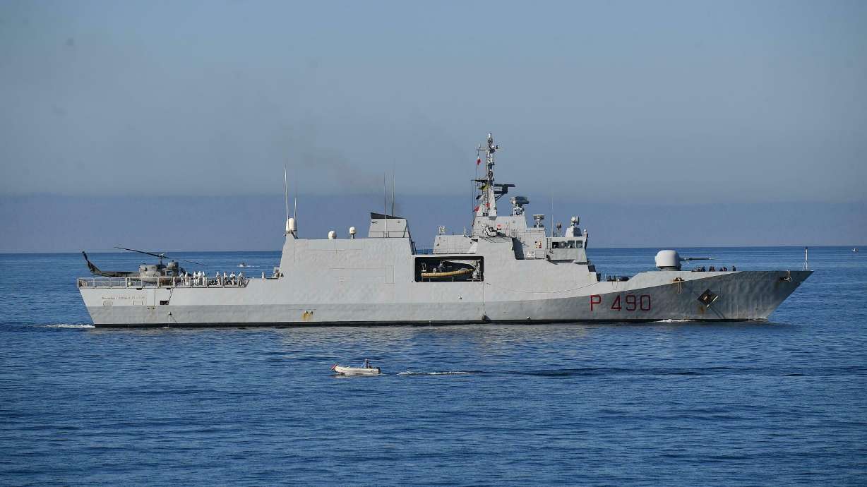 Italian navy ship with 100 rescued migrants docks in Genoa