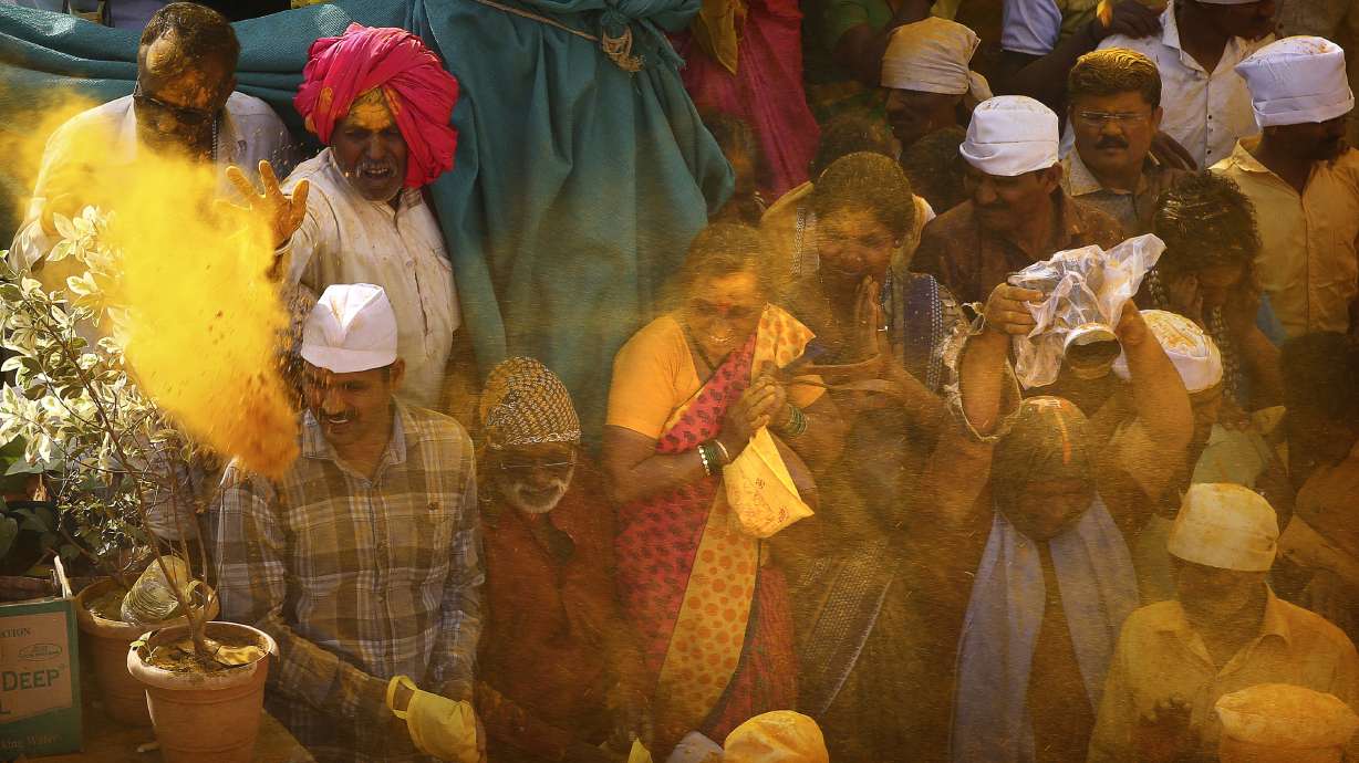 AP PHOTOS: Hindu festival showers Indian town with turmeric