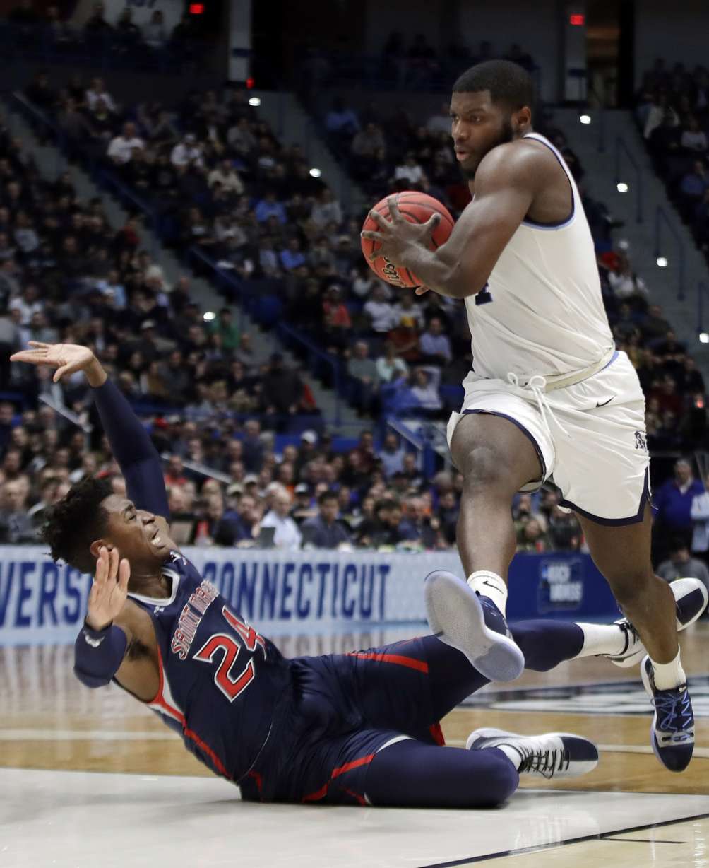 Villanova's Eric Paschall, right, drives against St. Mary's Malik Fitts (24) during the second half of a first round men's college basketball game in the NCAA Tournament, Thursday, March 21, 2019, in Hartford, Conn. (AP Photo/Elise Amendola)