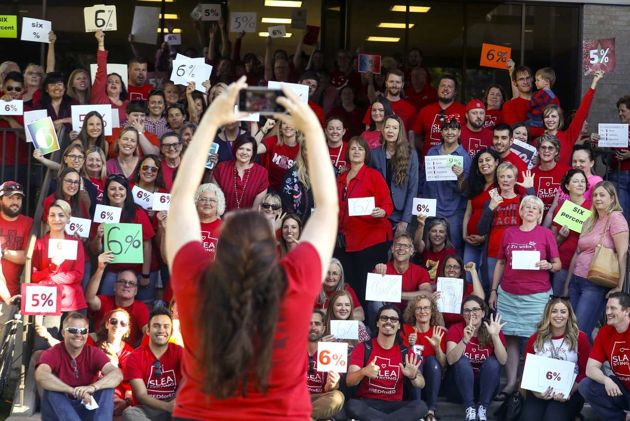 Angel Vice takes a photo of Salt Lake City School District teachers after they packed into the Salt Lake City School District Board meeting in Salt Lake City on Tuesday, June 4, 2019. While the school district has proposed a 3 percent raise for teachers, the demonstrators carried signs declaring 5 percent and 6 percent, representing how much they believe their pay should increase. (Photo: Steve Griffin, KSL)