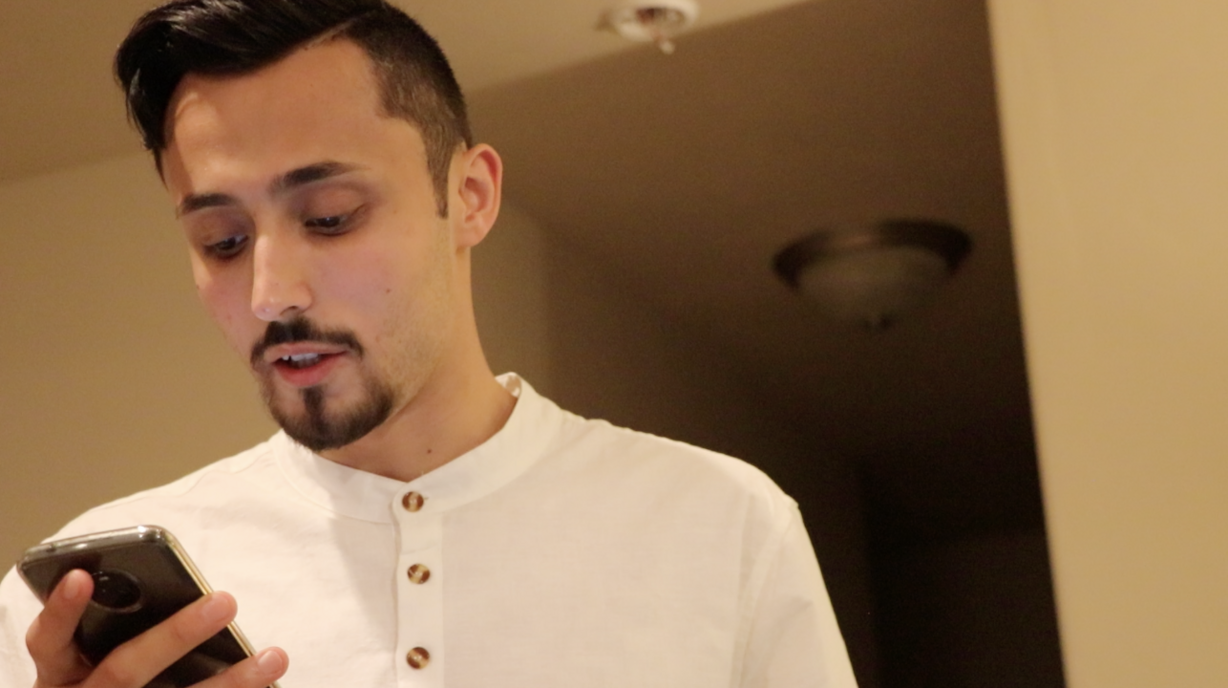 Muhammed Kariparduc reads an Islamic prayer translated to English to the family's neighbors who have gathered for iftar Saturday, June 1, 2019. (Photo: Liesl Nielsen, KSL.com)