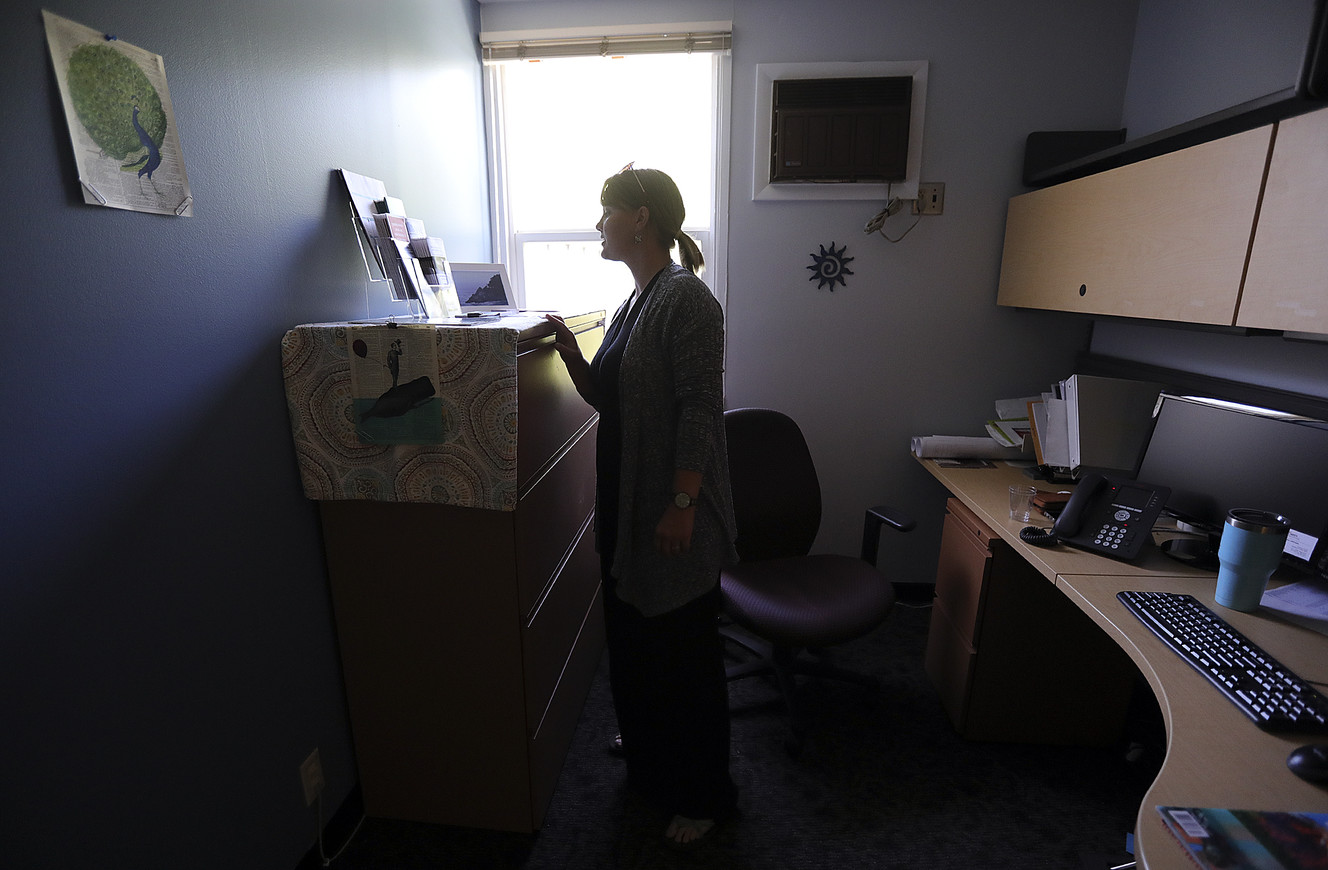 Jamie Justice, newly hired victim's advocate, looks at pamphlets in her office at the University of Utah's Department of Public Safety in Salt Lake City on Tuesday, June 4, 2019. (Photo: Kristin Murphy, KSL)