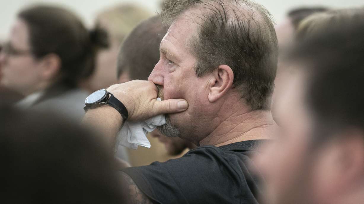 The Latest: Grisly and tender photos in dad's murder case