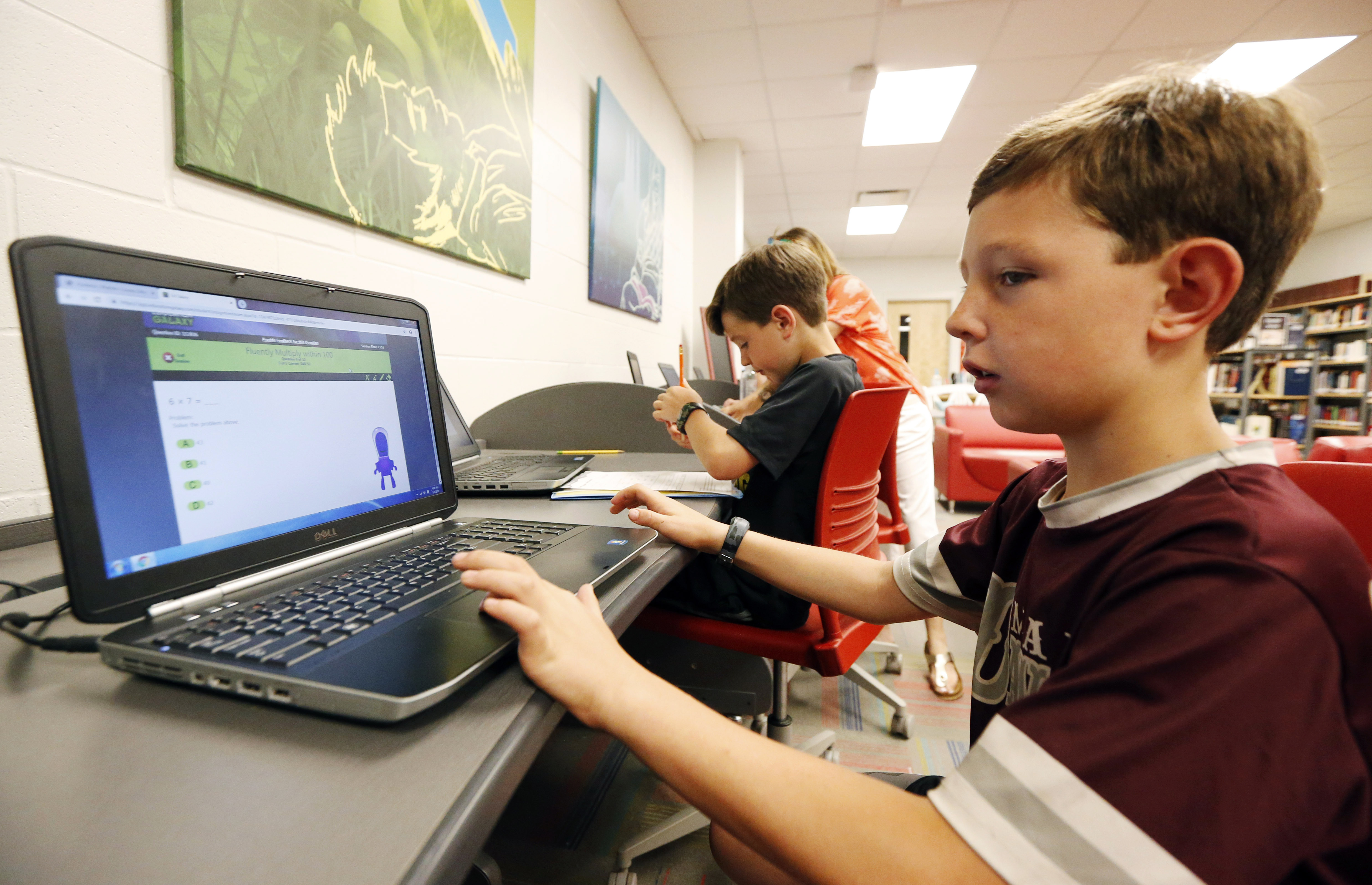 In this May 8, 2019, photo, third-grade student Miles Stidham uses an East Webster High School laptop to do homework in Maben, Miss. Photo: AP Photo