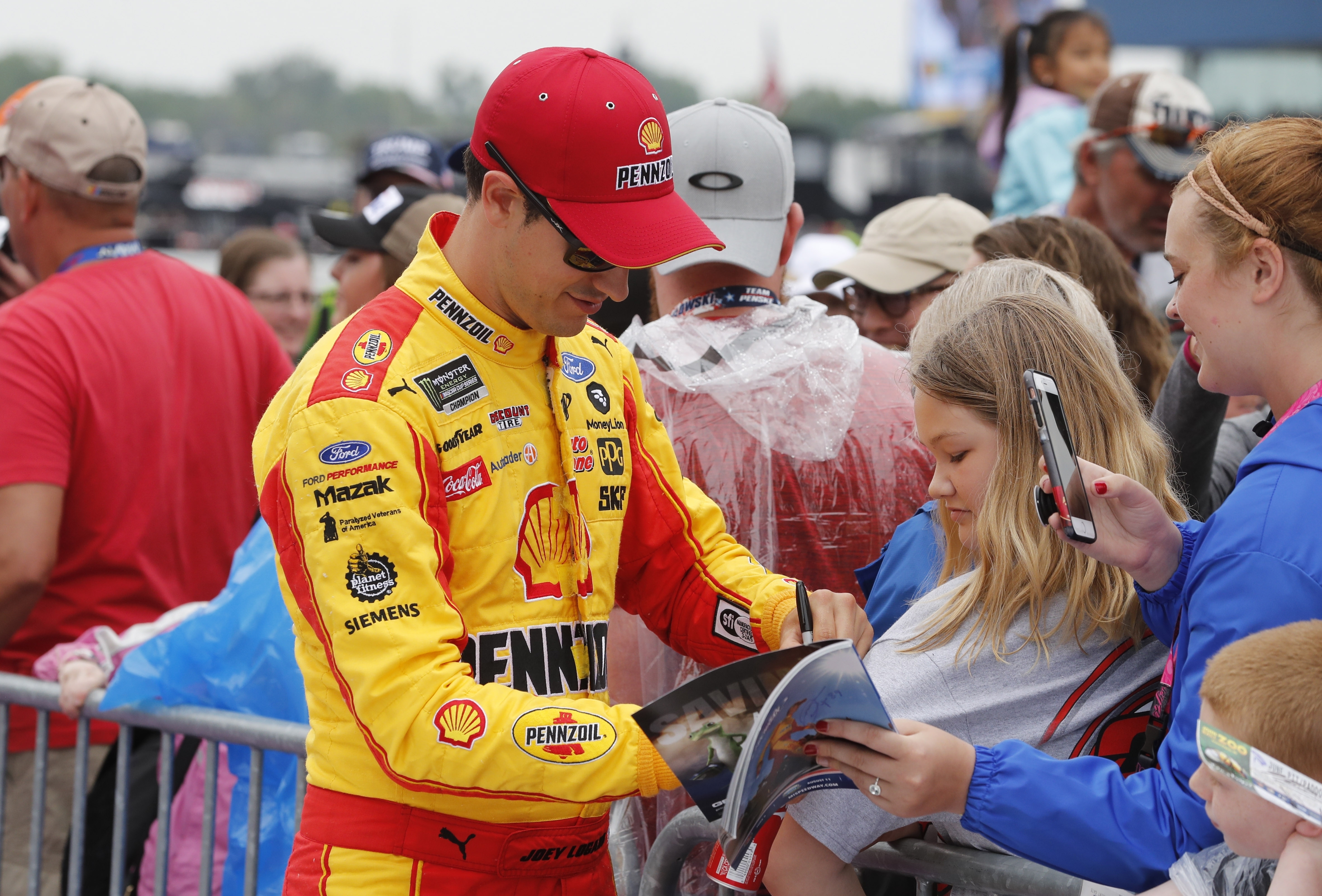 The Latest: Logano edges Kurt Busch, Truex in overtime