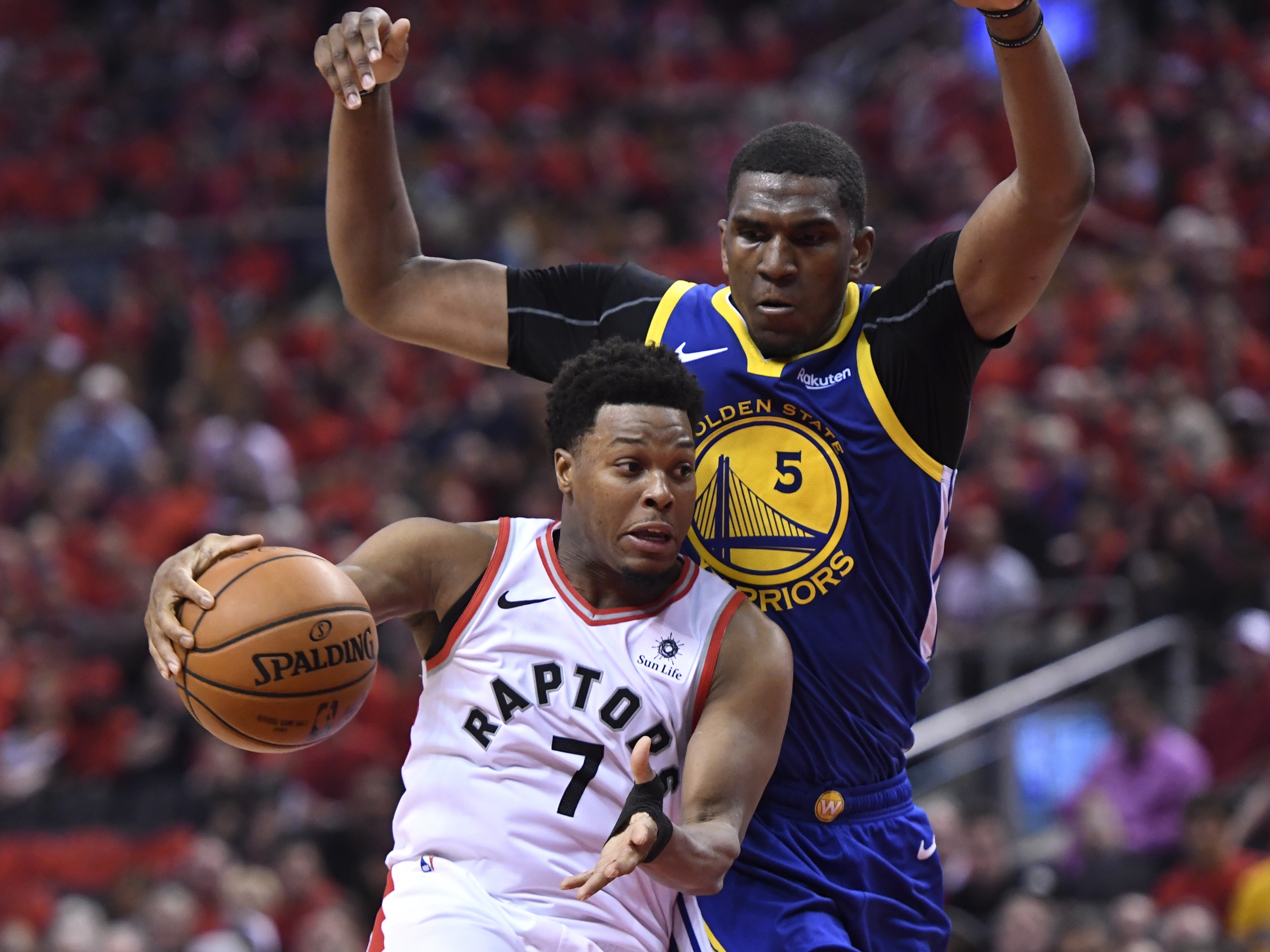 Toronto Raptors guard Kyle Lowry (7) handles the ball under pressure from Golden State Warriors center Kevon Looney (5) during second-half basketball action in Game 5 of the NBA Finals in Toronto, Monday, June 10, 2019. (Photo: Frank Gunn, The Canadian Press via AP)