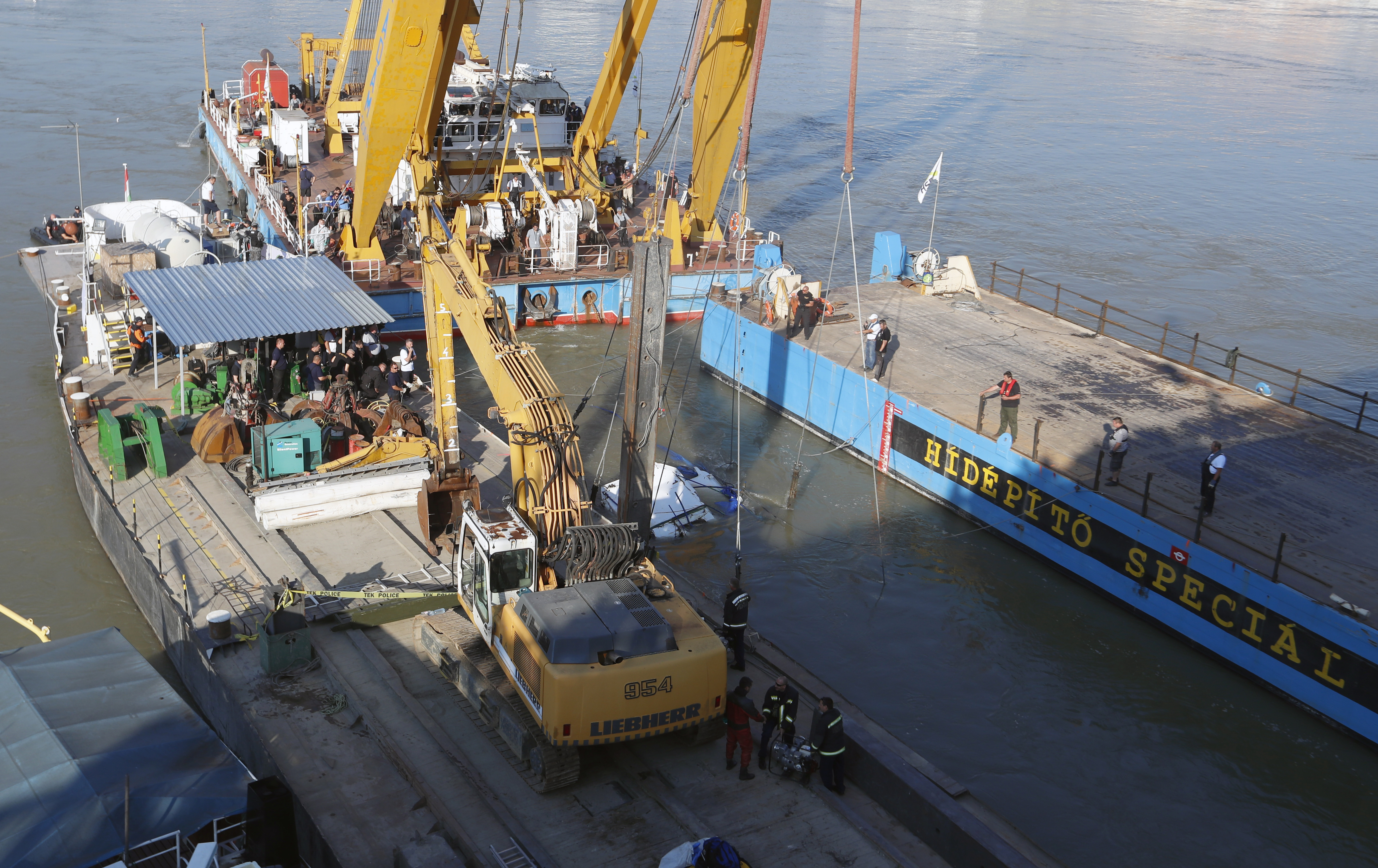 The Latest: Crane lifts sunken tour boat out of Danube River