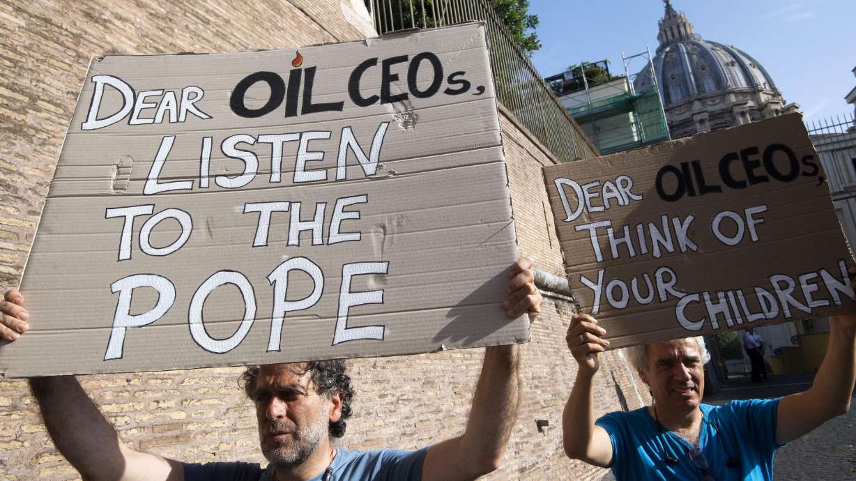 The Latest: Oil firms commit to 'meaningful' carbon pricing