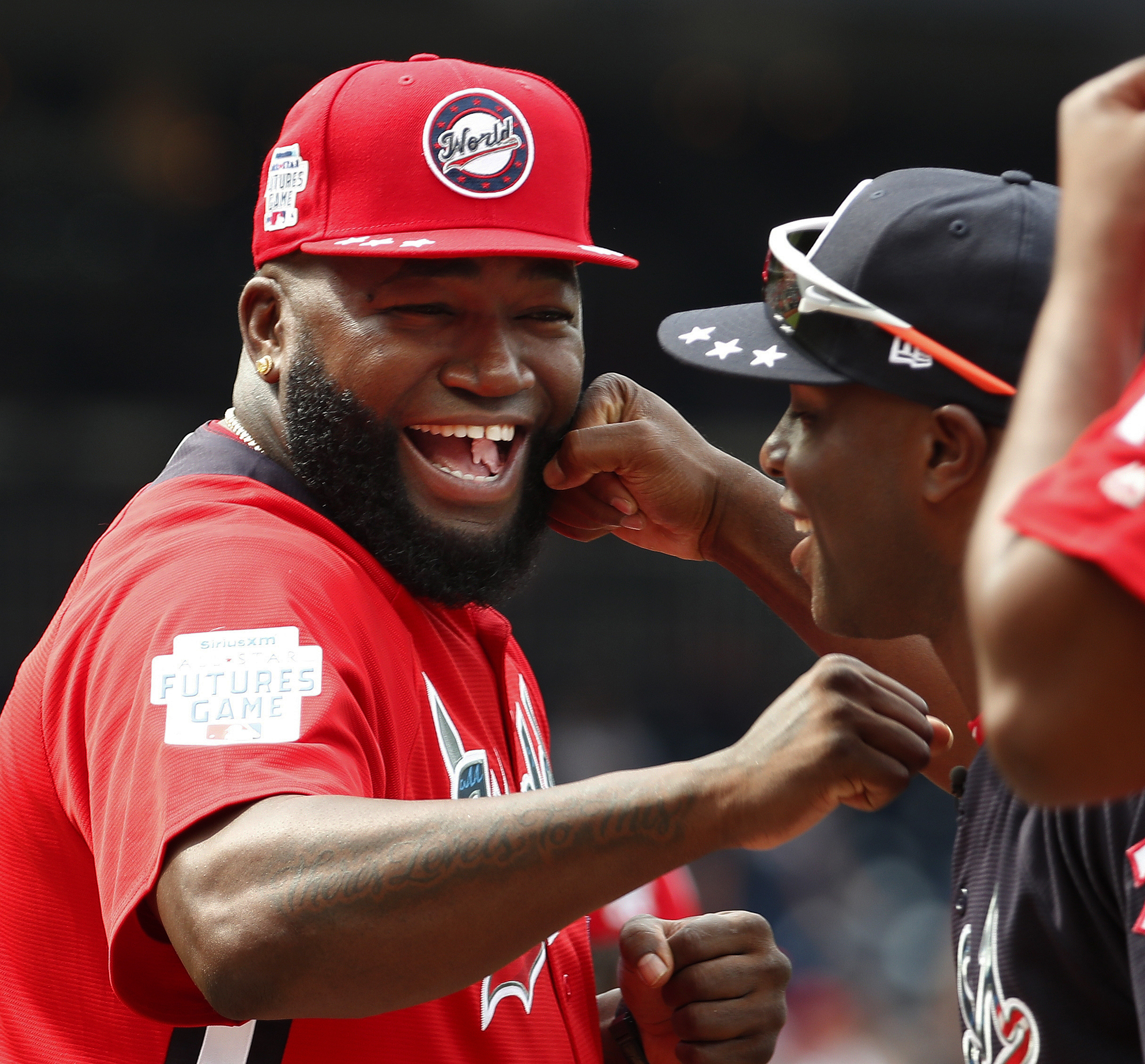 In this July 15, 2018, file photo, World Team Manager David Ortiz (34) speaks with U.S. Team Manager Torrii Hunter, before the All-Star Futures baseball game at Nationals Park, in Washington. Ortiz returned to Boston for medical care after being shot in a bar Sunday, June 9, 2019, in his native Dominican Republic. (AP Photo/Alex Brandon, File)