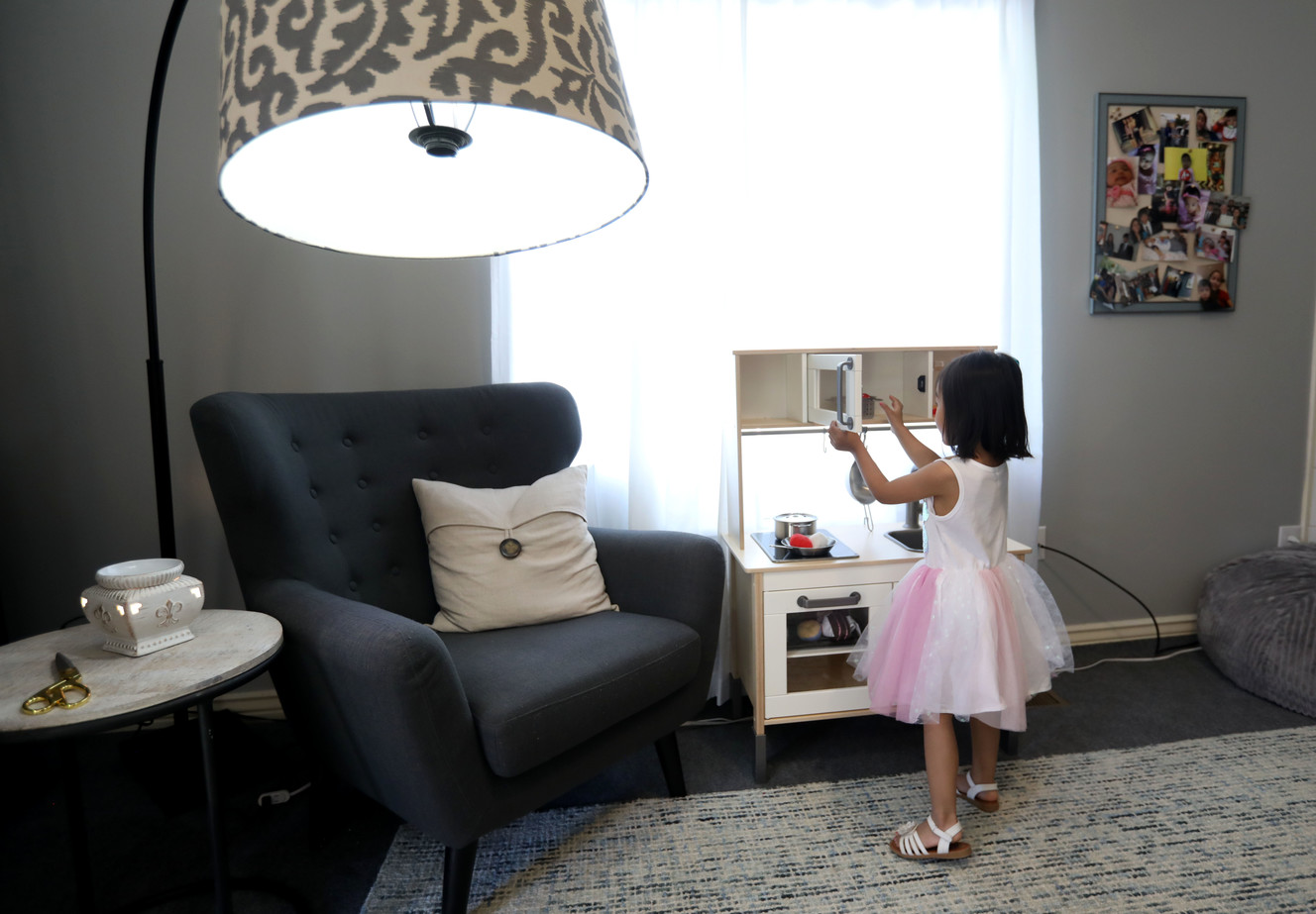 Allysia Gurung plays with her kitchen set in her remodeled home in Salt Lake City on Thursday, June 20, 2019. (Photo: Laura Seitz, KSL)