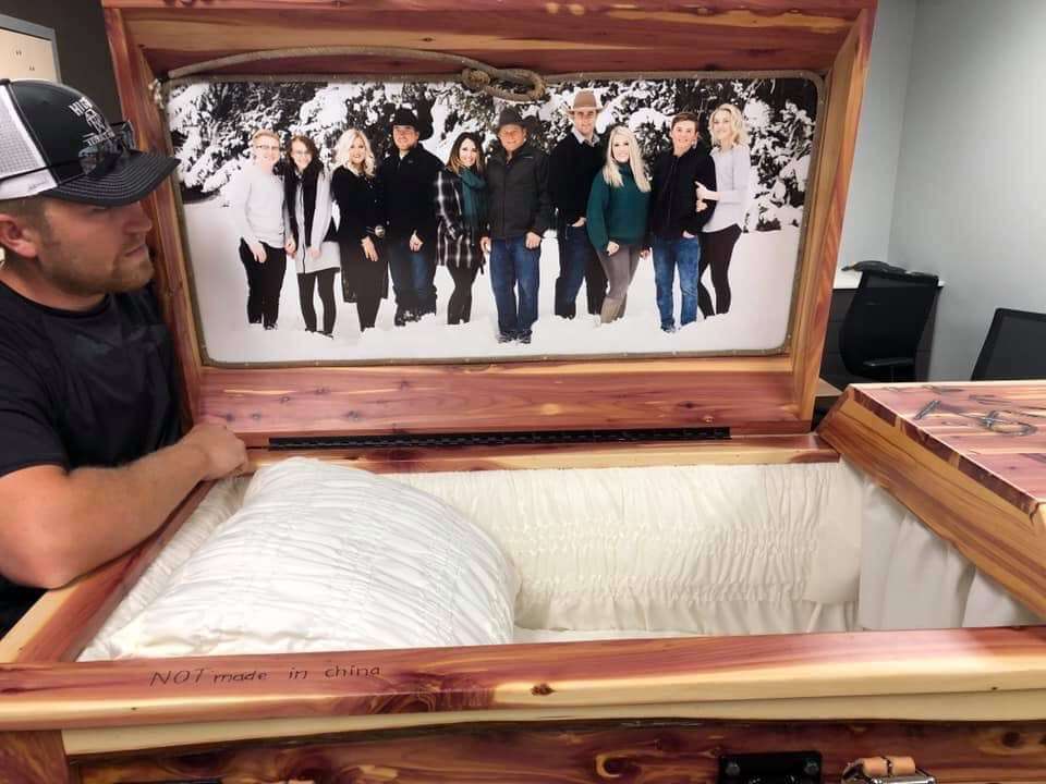 Larsen's fellow linemen and others built the "real-life cowboy" a custom-made casket, complete with the family's cattle and horse brands etched on the outside and a picture of the family on the inside. (Photo: Courtesy of Angie Larsen)
