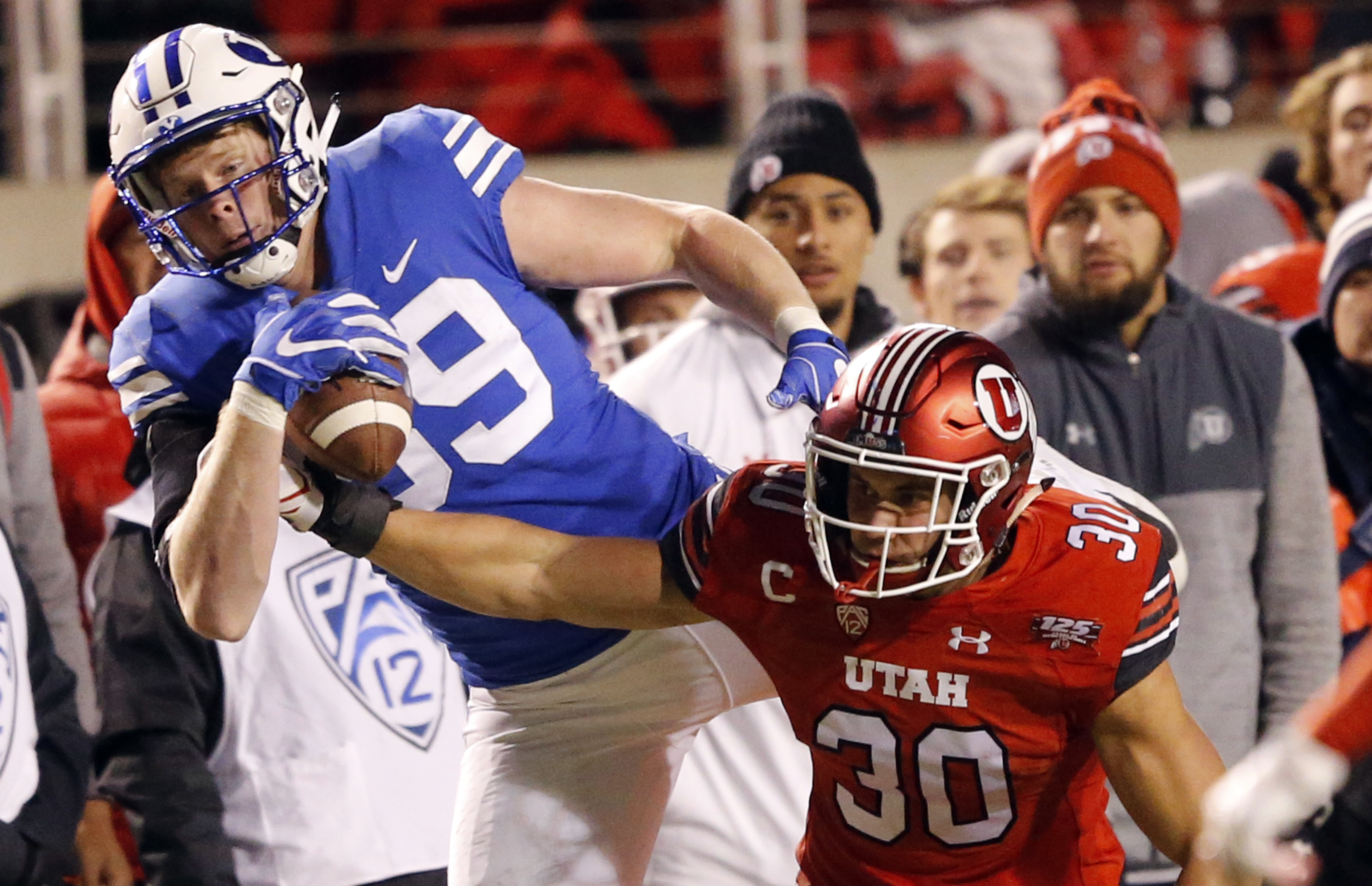 BYU tight end Matt Bushman, rear, makes a reception against Utah Utes linebacker Cody Barton (30) in the second half during an NCAA college football game Saturday Nov. 24, 2018, in Salt Lake City. The Utes will take a 9-game winning streak in LaVell Edwards Stadium into Saturday's continuation of the rivalry series.