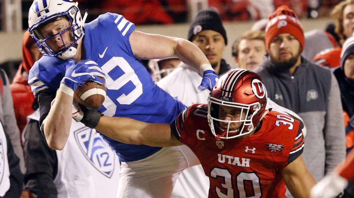 BYU tight end Matt Bushman, rear, makes a reception against Utah Utes linebacker Cody Barton (30) in the second half during an NCAA college football game Saturday Nov. 24, 2018, in Salt Lake City. (AP Photo/Rick Bowmer)