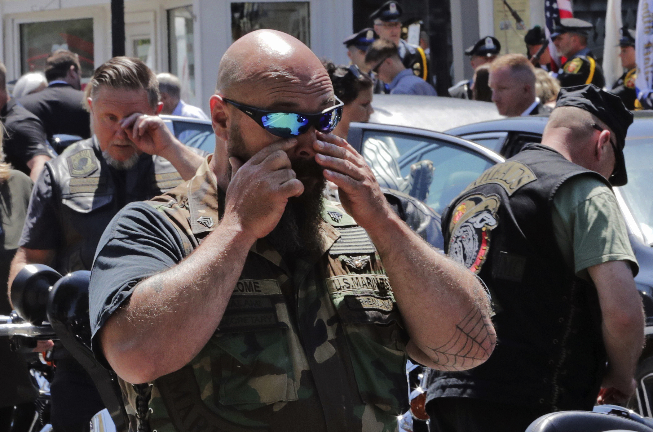 The Latest: Biker killed remembered as public servant