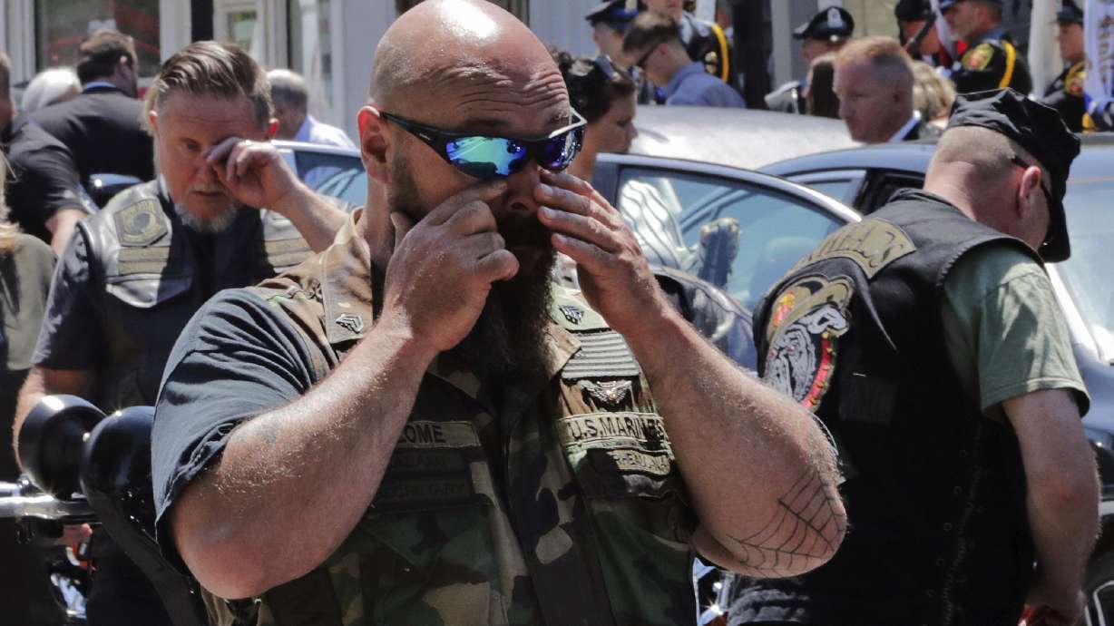 The Latest: Biker killed remembered as public servant