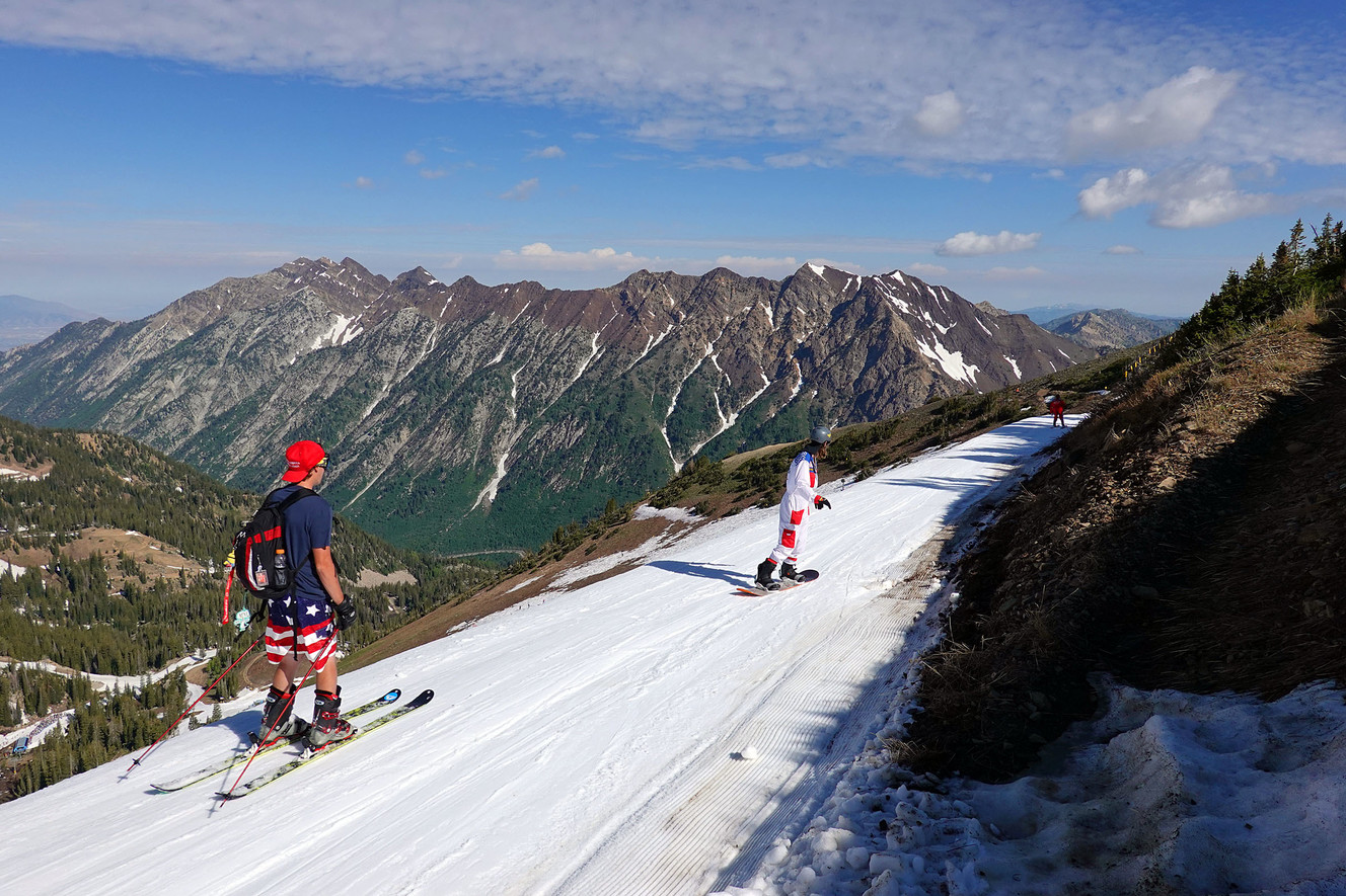 Skiers and snowboarders glide down a cat track at Snowbird on Thursday, July 4, 2019. (Photo: Ravell Call, KSL)
