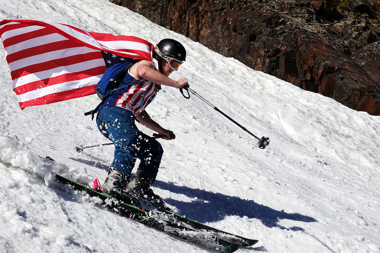 Daniel Wells skis with a flag over his shoulders at Snowbird on Thursday, July 4, 2019. (Photo: Ravell Call, KSL)