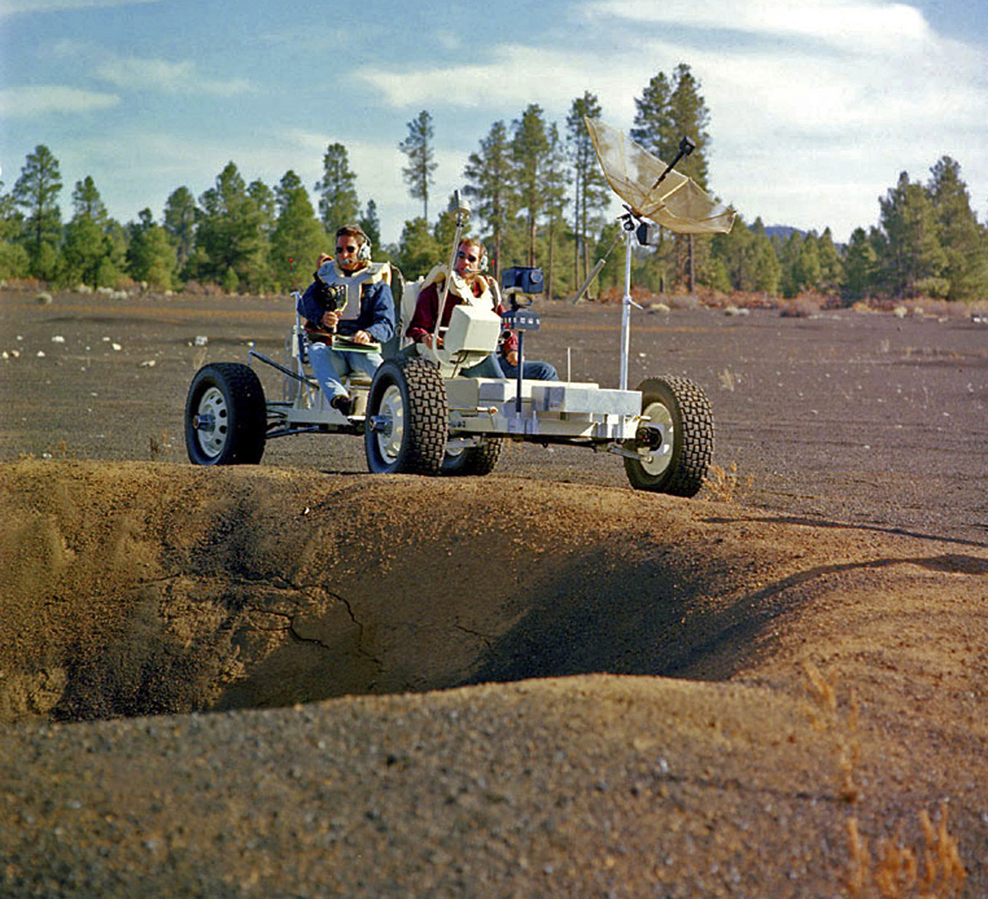 This undated photo provided by the U.S. Geological Survey Astrogeology Science Center shows Apollo 15 astronauts Jim Irwin, left, and Dave Scott driving a prototype of a lunar rover in a volcanic cinder field east of Flagstaff, Ariz. photo: U.S. Geological Survey Astrogeology Science Center