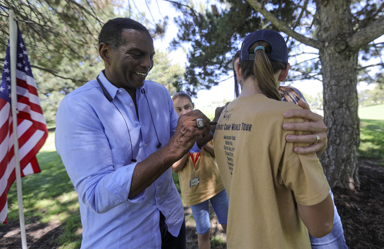 Burgess Owens, former Oakland Raiders defensive back, autographs Chloe Mercer's shirt during Patriot Camp at Murray Park in Murray on Wednesday, July 10, 2019. (Photo: Kristin Murphy, KSL)