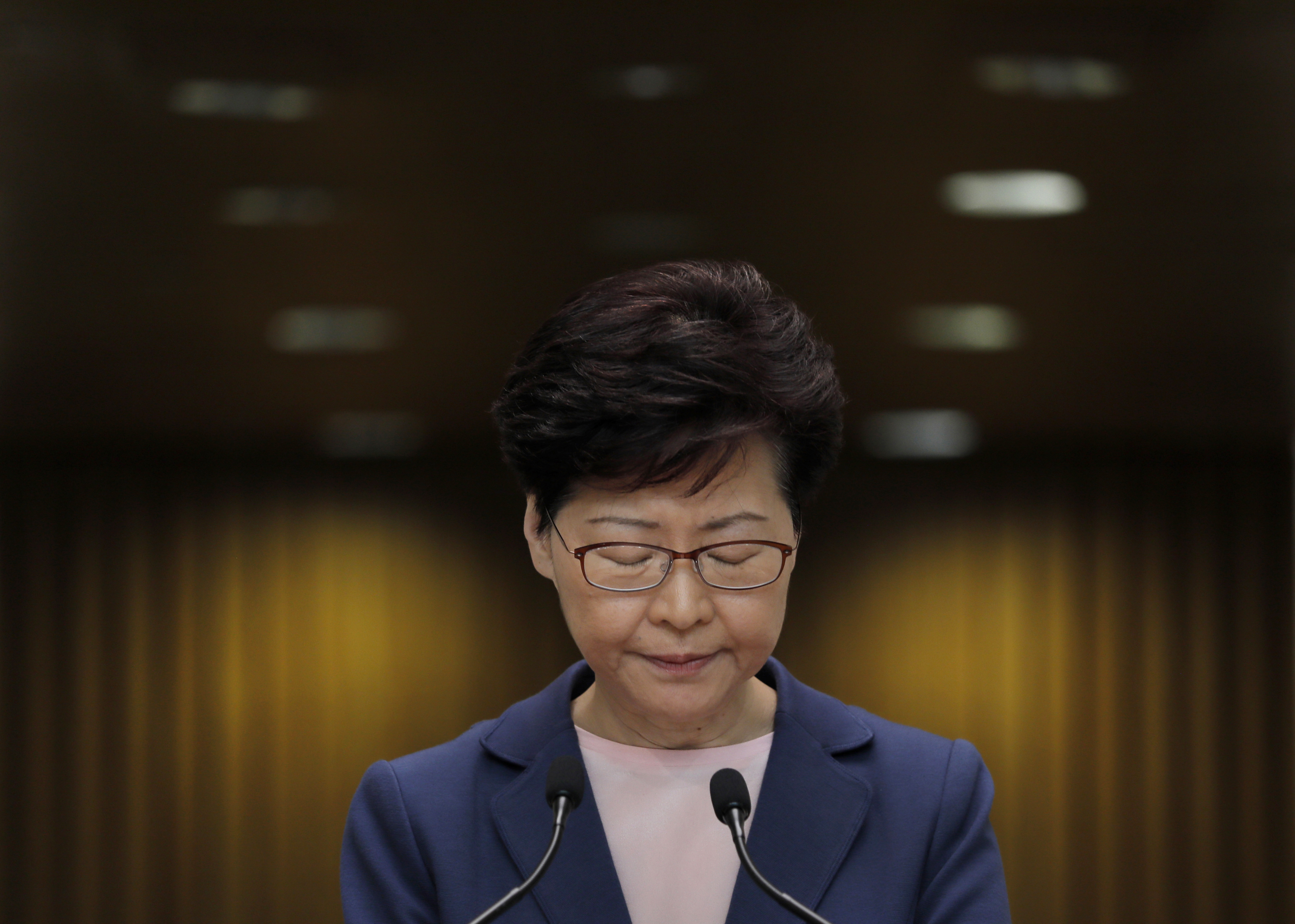 Hong Kong protesters march with mock coffin of city leader