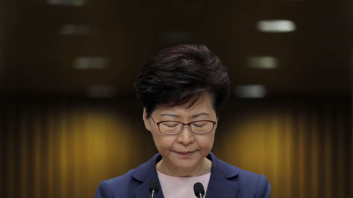 Hong Kong protesters march with mock coffin of city leader