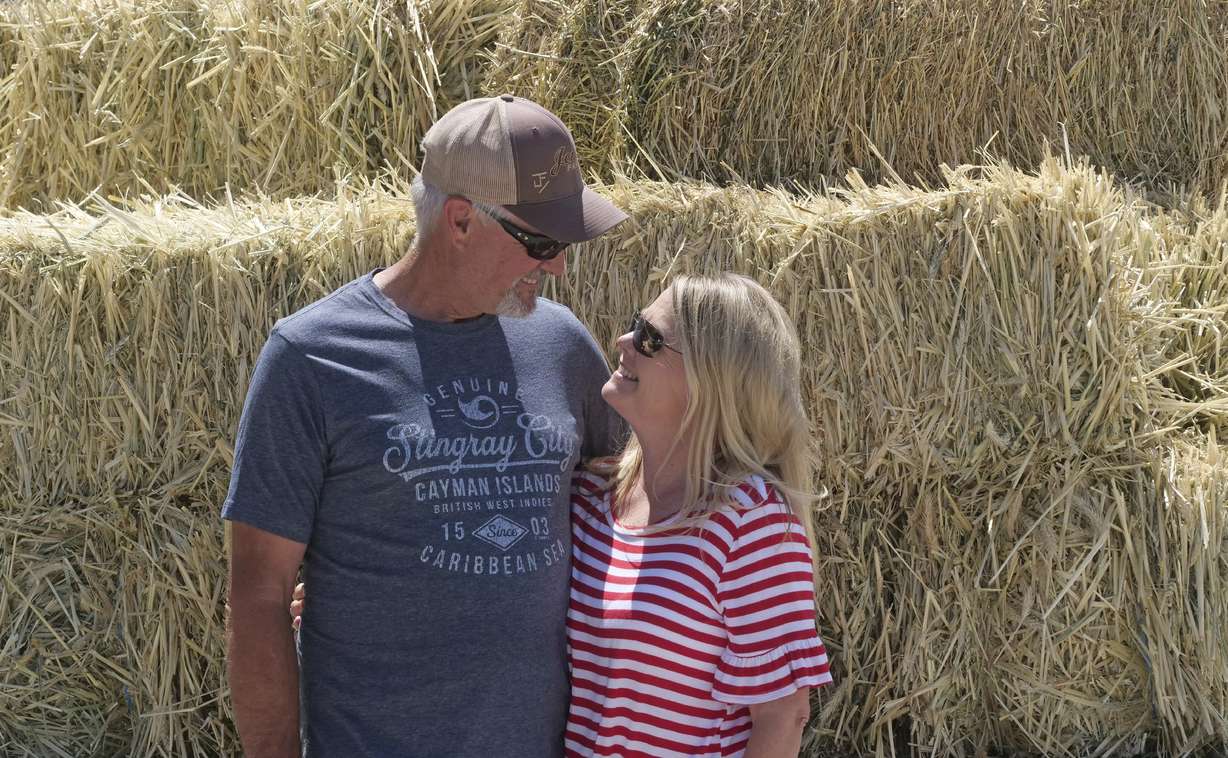 In this Wednesday, June 26, 2019, photo, Russell and Diane Jones stand in front of alfalfa at their farm, in Nephi, Utah. Photo: Morgan Smith, AP Photo