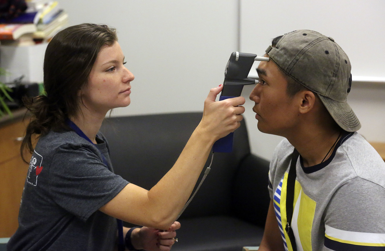 Madeline Giles, an intern with Friends for Sight, checks James Paris' eye pressure during a glaucoma screening at the 27th annual Community Assistance and Resource Event Fair, Utah’s largest free health fair, at Horizonte Instruction and Training Center in Salt Lake City on Friday, July 12, 2019. (Photo: Kristin Murphy, KSL)