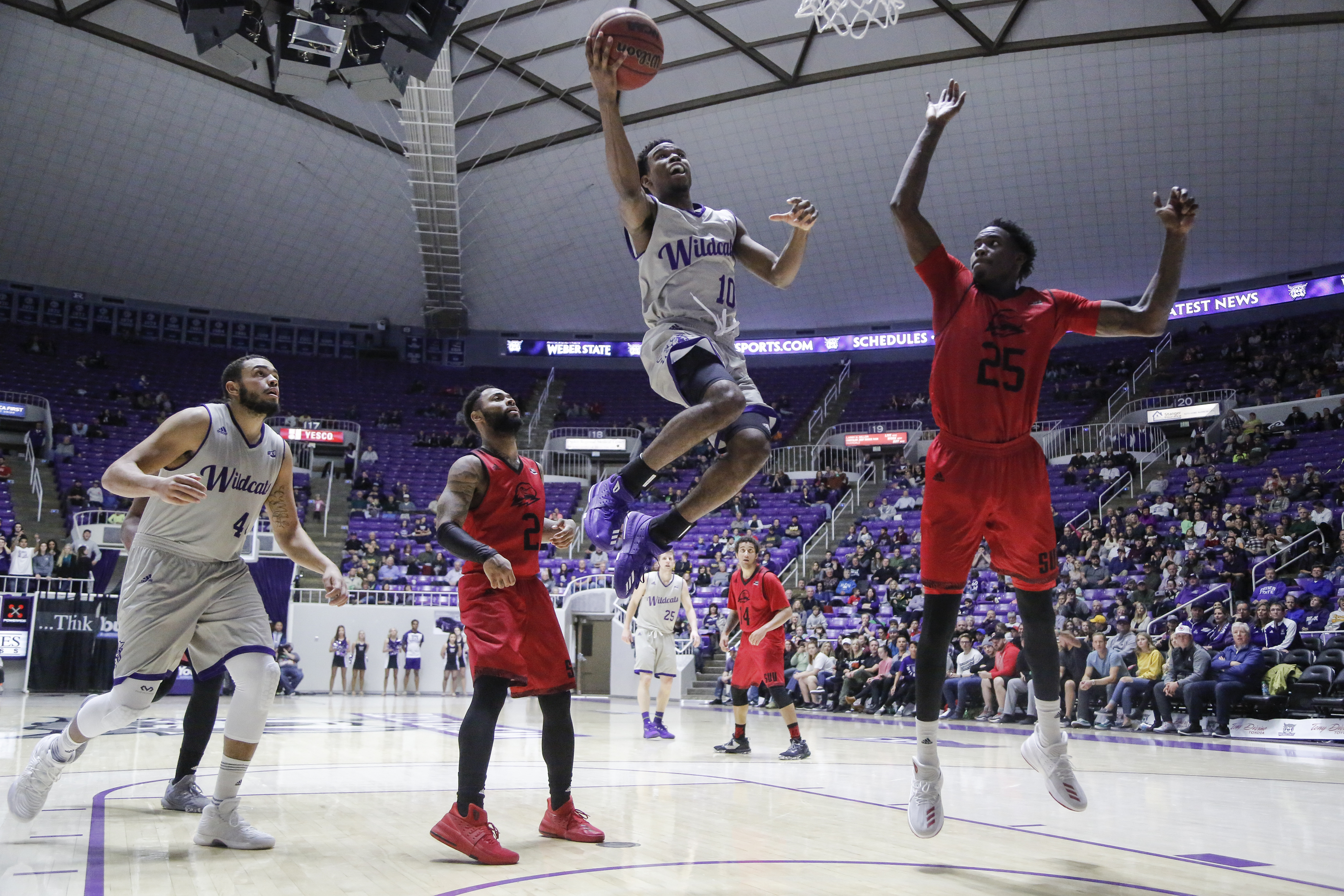 Weber State's Jerrick Harding (10) goes up for a layup past Southern Utah's Brandon Better (2) and Dwayne Morgan (25) during the second half of an NCAA college basketball game Saturday, Jan. 6, 2018, in Ogden, Utah. (Photo: Matt Herp, Standard-Examiner via AP, File)
