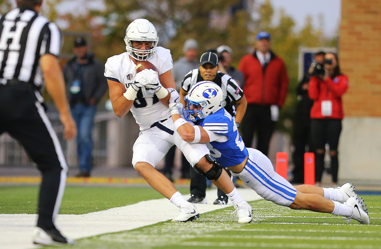 Utah State Agges tight end Dax Raymond (87) makes a catch just as he is hit by Brigham Young defensive back Zayne Anderson (23) as BYU and USU play at Maverik Stadium in Logan, Friday, Sept. 29, 2017. (Photo: Scott G Winterton, KSL)
