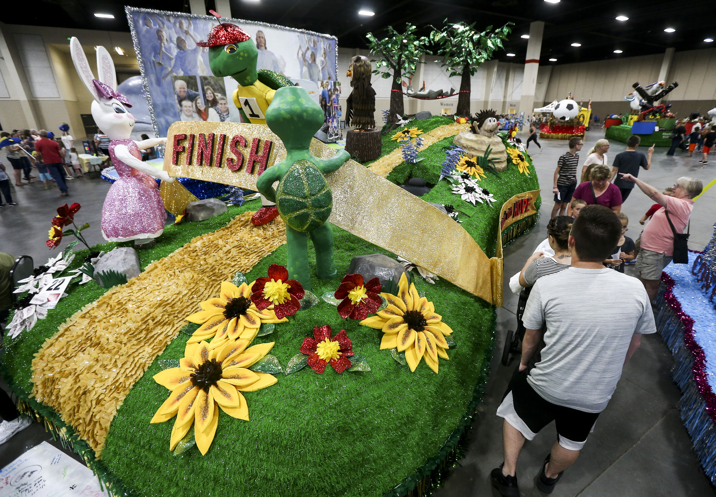 Event goers check out the Riverton Western Springs Stake float featuring the story of the Tortoise and the Hare during the Days of 47 Float Preview at the Mountain America Expo Center in Sandy on Monday, July 22, 2019. Float makers put their floats on display Monday and Tuesday for the community to get up close before the parade. (Photo: Colter Peterson, KSL.)
