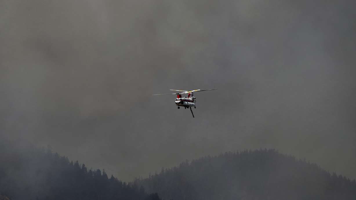 The Latest: Flash flood warning for areas below wildfire