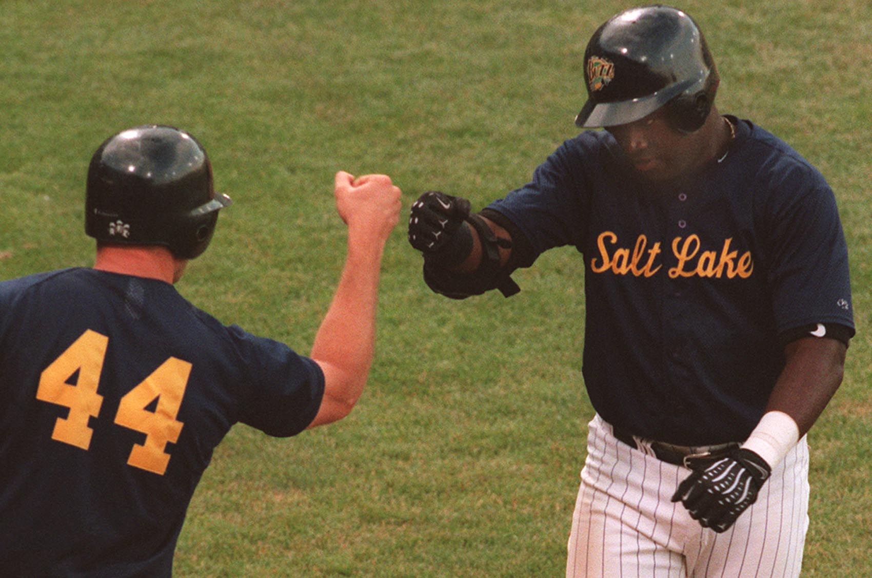 Salt Lake Buzz player Brian Buchanan, left, greets David Ortiz after Ortiz hits a home run in a game against Tucson at Franklin Covey Field on July 8, 1999. (Morta Storwick, Deseret News Photo Archives)