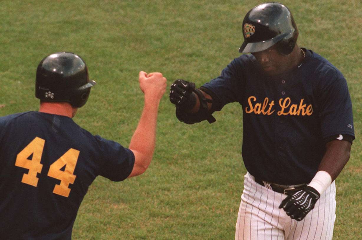 Salt Lake Buzz player Brian Buchanan, left, greets David Ortiz after Ortiz hits a home run in a game against Tucson at Franklin Covey Field on July 8, 1999. (Morta Storwick, Deseret News Photo Archives)