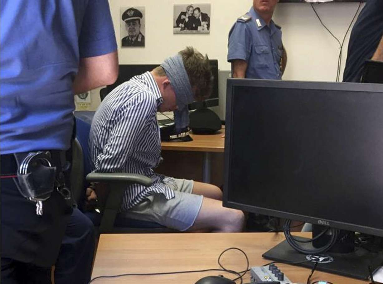 In this photo obtained from Italian Carabinieri, Gabriel Christian Natale-Hjorth sits blindfolded in a police station in Rome on Friday July 26, 2019. Photo: Italian Carabinieri, AP Photo