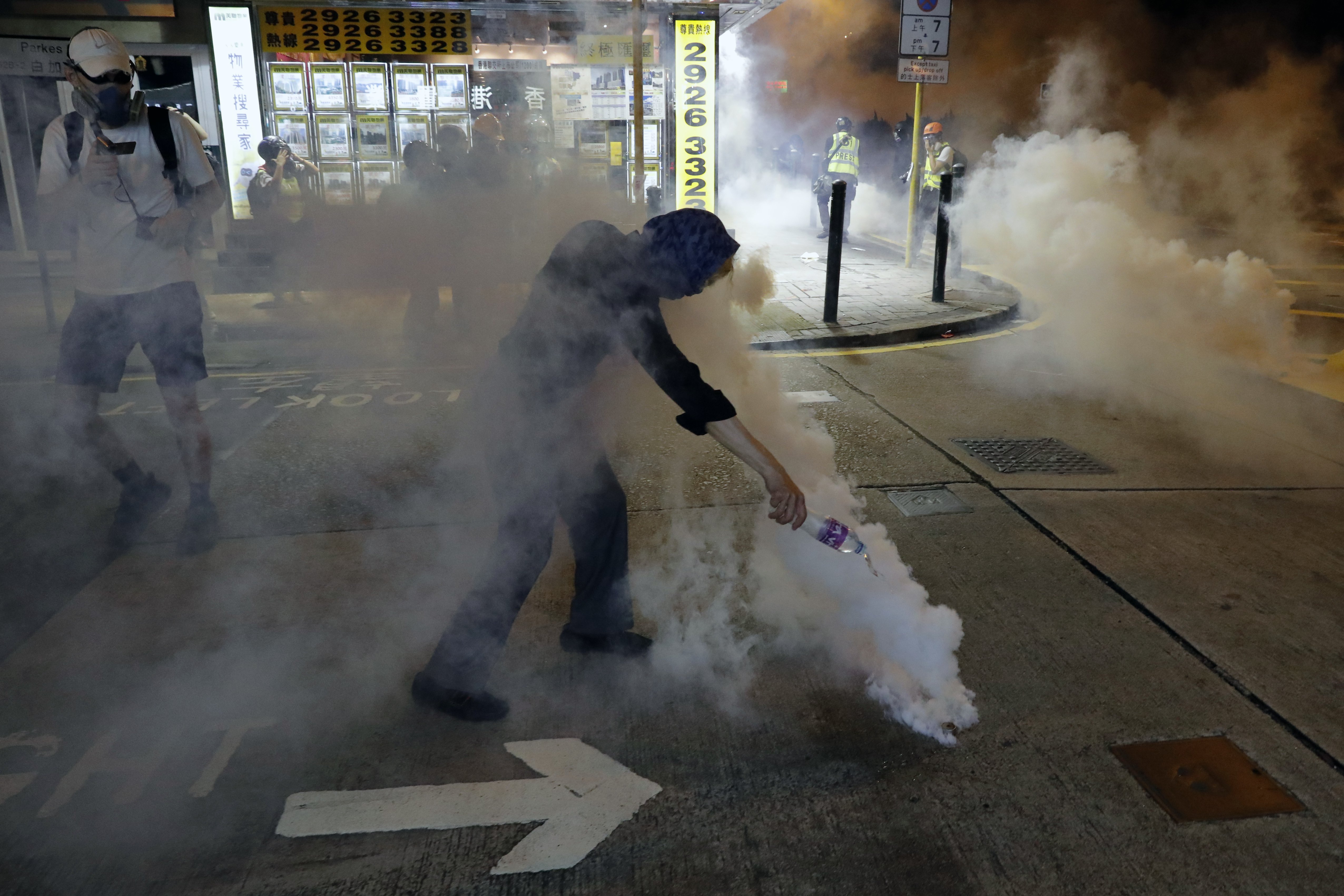 The Latest: HK police tear gas protesters in shopping area
