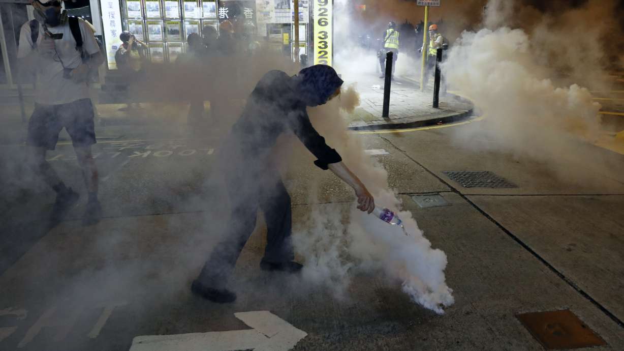 The Latest: HK police tear gas protesters in shopping area