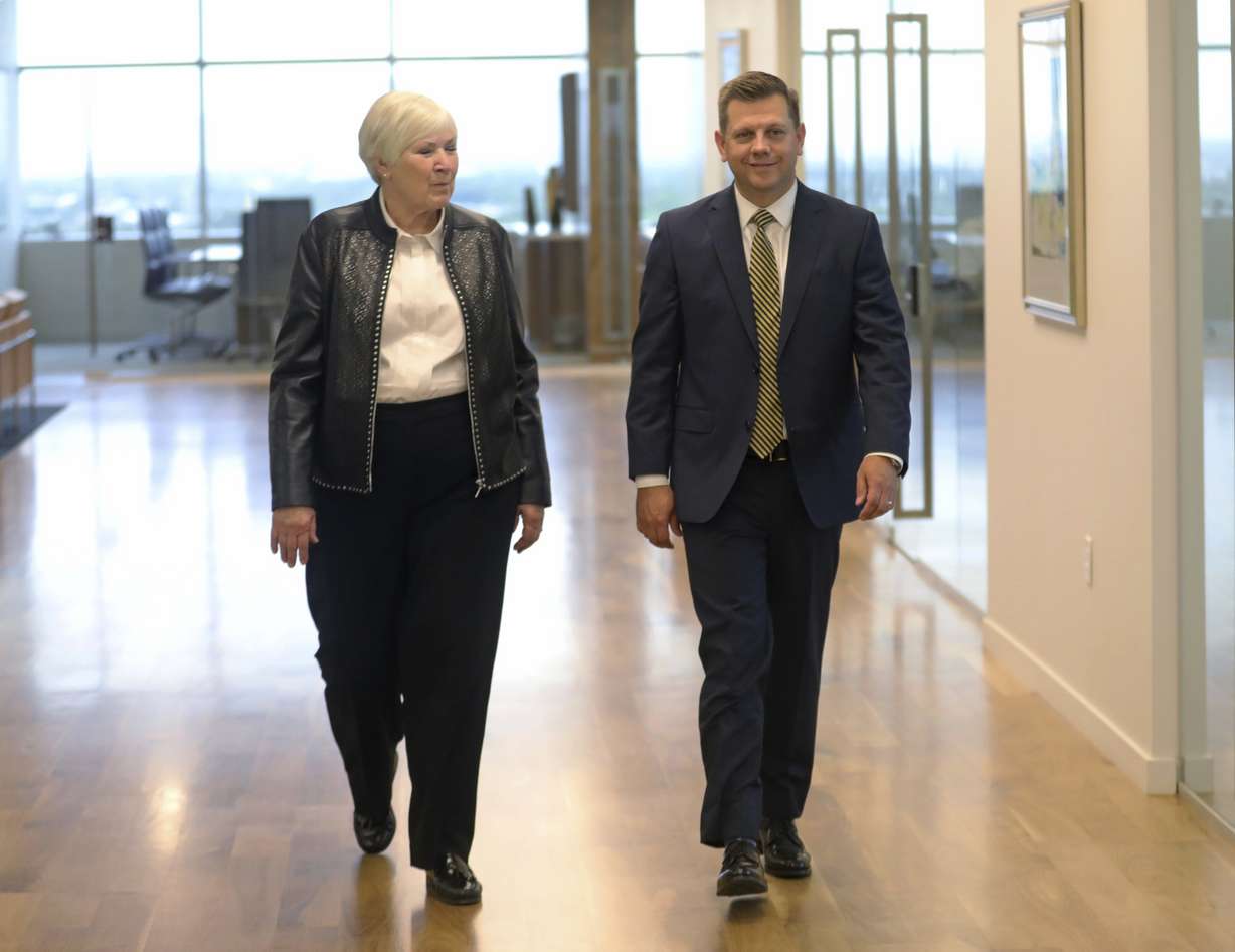Gail Miller, left, chairman and owner of the Larry H. Miller Group of Companies and Steve Starks, right, walk together Wednesday, Aug. 7, 2019, in Sandy, Utah. Utah Jazz president Starks has been named the new CEO of the Larry H. Miller Group of Companies. (AP Photo/Rick Bowmer)