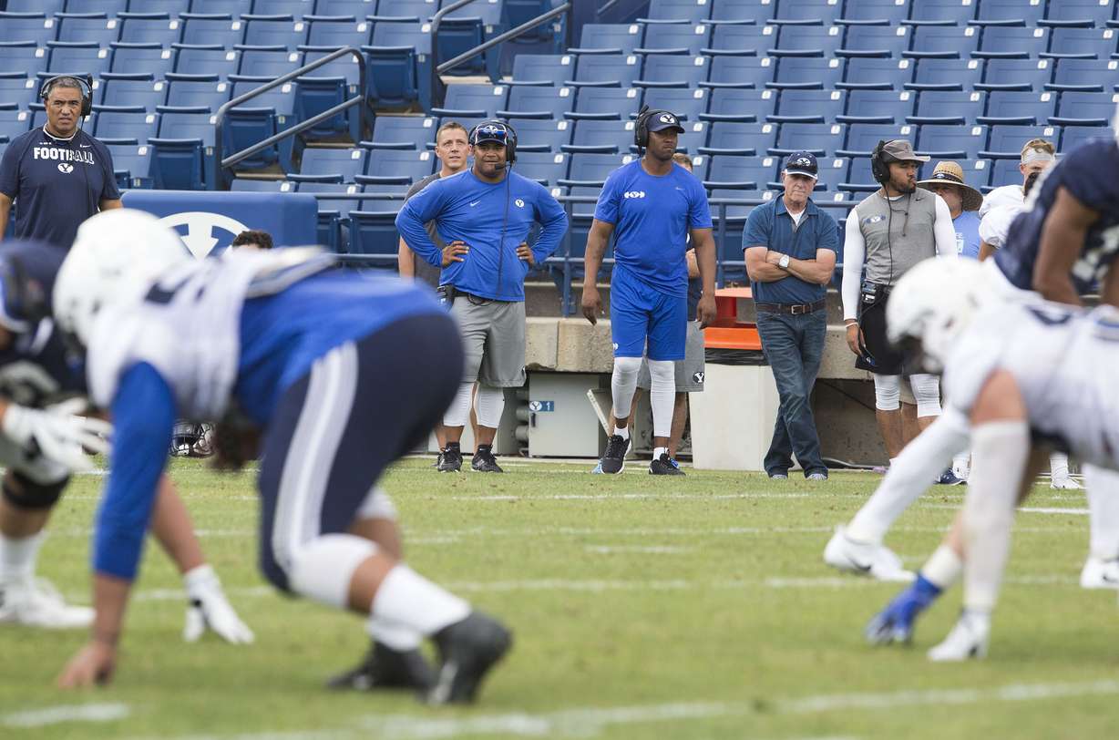 BYU defensive coordinator Ilaisa Tuiaki, center, watches the scrimmage with other coaches at a BYU football practice in Provo on Thursday, August 10, 2017. (Photo: Kelsey Brunner, KSL)