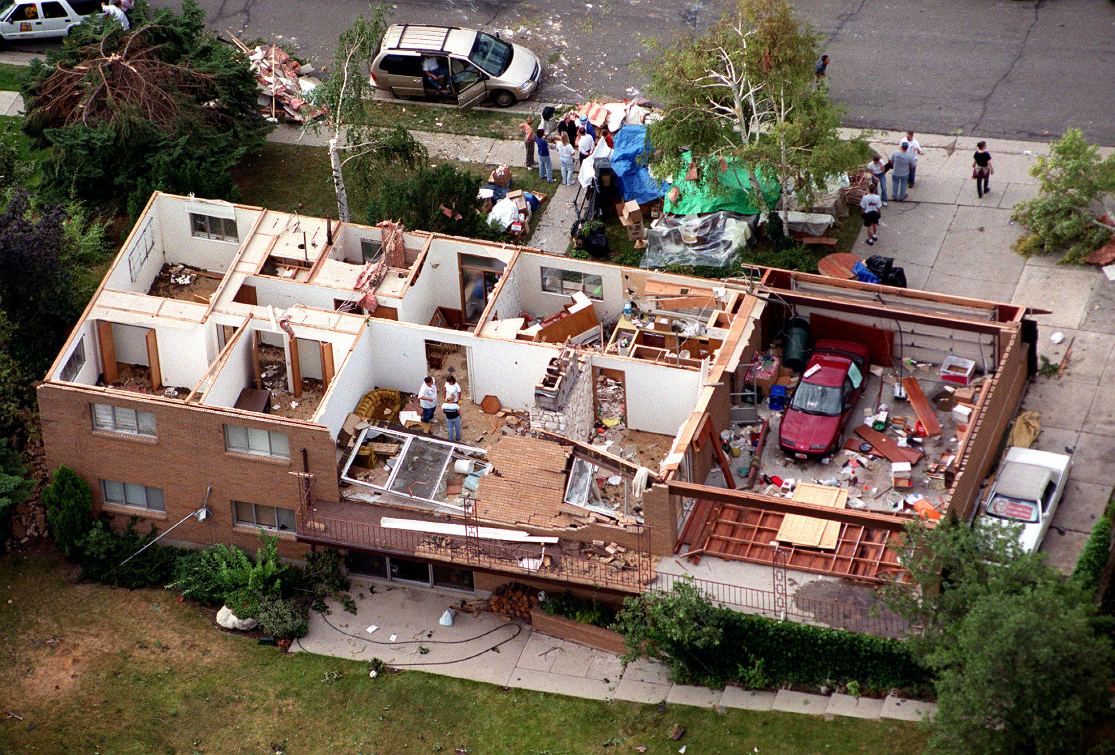 A house in the Upper Avenues neighborhood of Salt Lake City, Utah lost its entire roof as a rare and sudden tornado swept through the city Wednesday, August 11, 1999. (Photo: Gary McKellar, Deseret News Photo Archive)