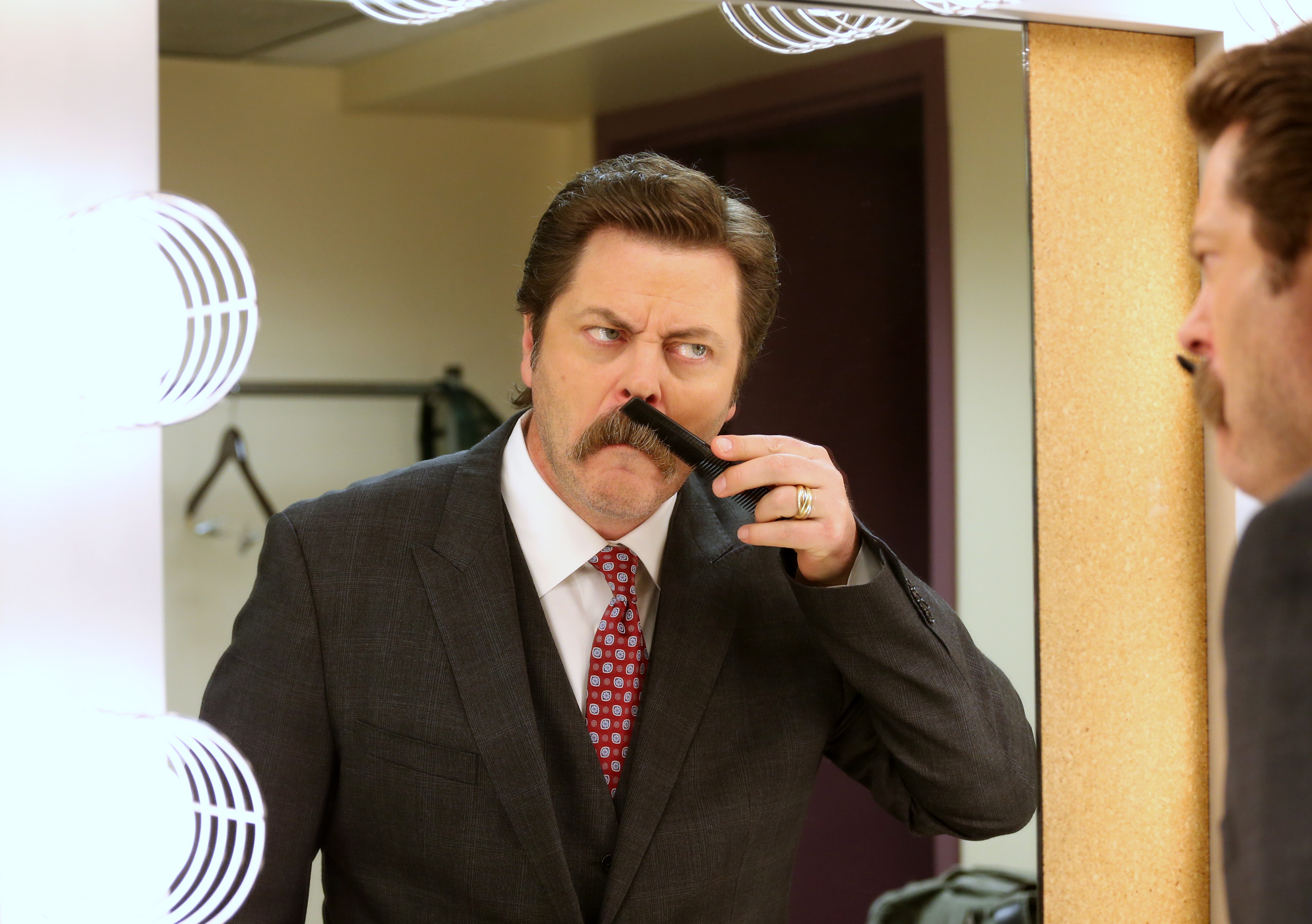 Nick Offerman combs his moustache backstage as he prepares to host The Hollywood Reporter Key Art Awards Powered by Clio at the Dolby Theatre on Thursday, Oct. 23, 2014, in Los Angeles. (Photo: Omar Vega, Invision for The Hollywood Reporter via AP Images)