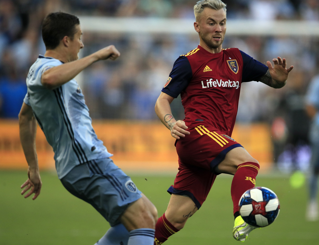 Real Salt Lake midfielder Albert Rusnak, right, breaks past Sporting Kansas City defender Matt Besler during the first half of an MLS soccer match in Kansas City, Kan., Saturday, Aug. 10, 2019. (Photo: Orlin Wagner, AP)