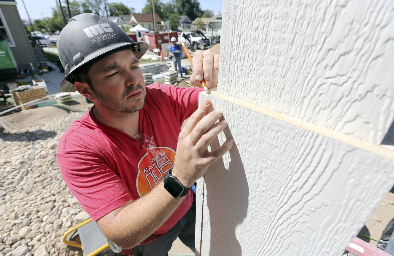 Brenton Fite, Wadman Corporation estimator, checks a measurement while working on a home being built by HGTV's "Extreme Makeover: Home Edition," in Ogden on Monday, Aug. 12, 2019. (Photo: Kristin Murphy, KSL)
