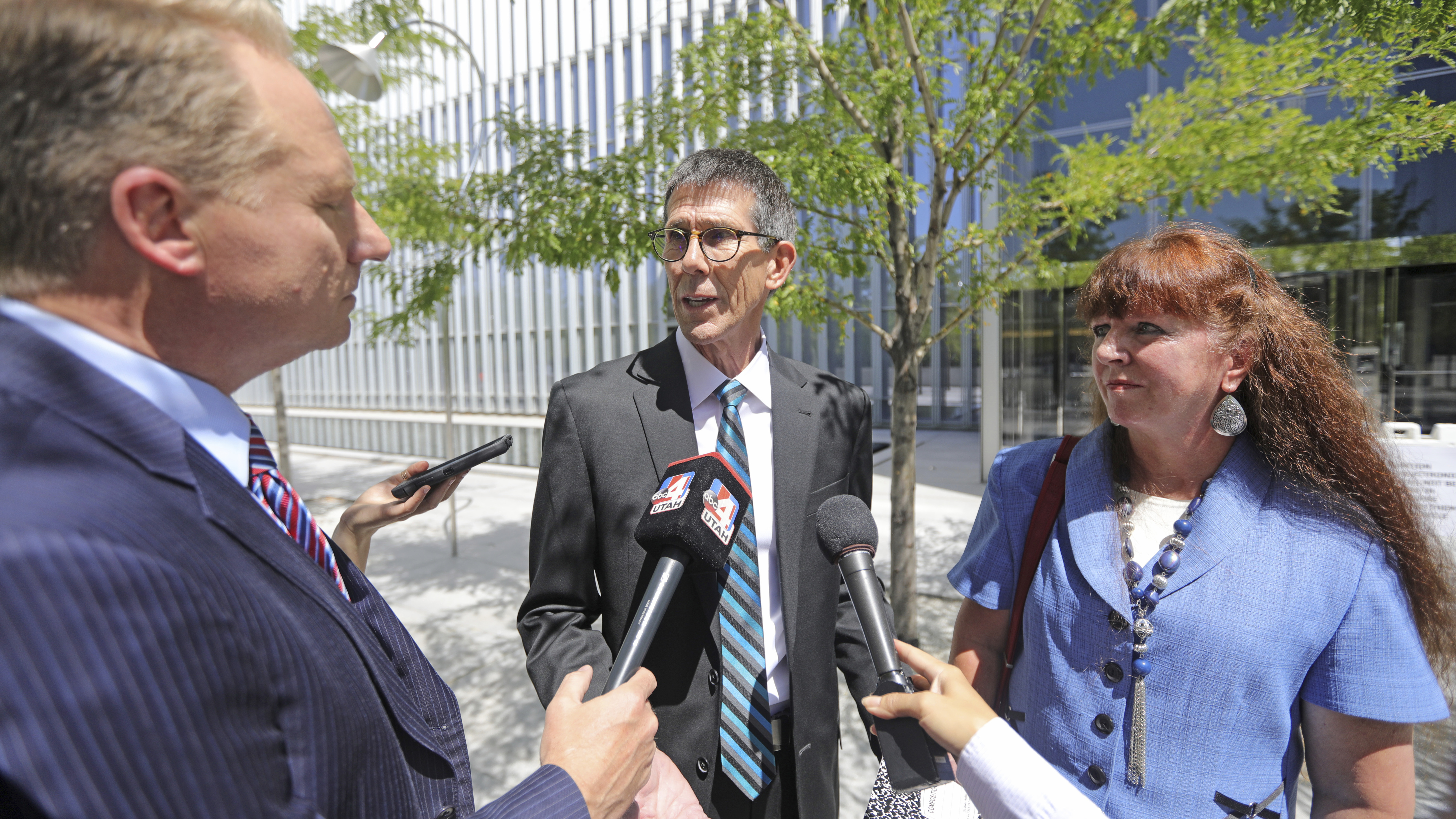 Mike and Becky Shamo, the parents of Aaron Shamo, speak with reporters at the federal courthouse Monday, Aug. 12, 2019, in Salt Lake City. Former Eagle Scout Aaron Shamo, 29, will stand trial on allegations that he and a small group of fellow millennials ran a multimillion-dollar empire from the basement of his suburban Salt Lake City home by trafficking hundreds of thousands of pills containing fentanyl, the potent synthetic opioid that has exacerbated the country's overdose epidemic in recent years. (Rick Bowmer, AP Photo)