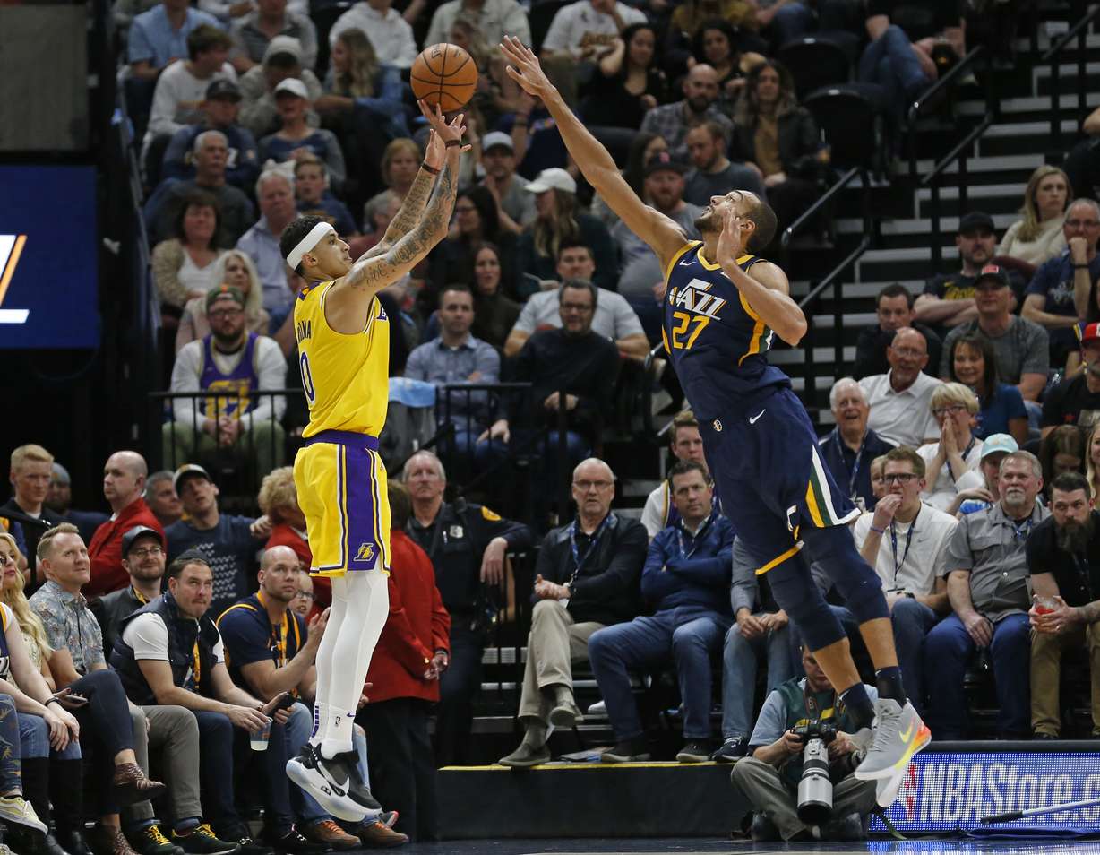 Utah Jazz center Rudy Gobert (27) defends against Los Angeles Lakers forward Kyle Kuzma, left, during the second half of an NBA basketball game Wednesday, March 27, 2019, in Salt Lake City. (Rick Bowmer, AP Photo)