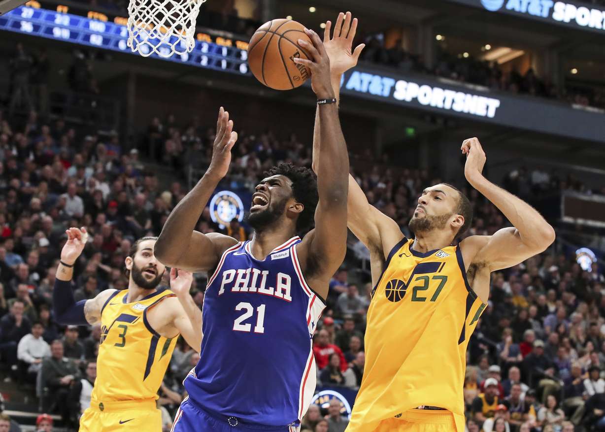 Utah Jazz center Rudy Gobert (27) looks to block the shot of Philadelphia 76ers center Joel Embiid (21) during the second quarter of an NBA basketball game Thursday, Dec. 27, 2018, in Salt Lake City. (Chris Nicoll, AP Photo)