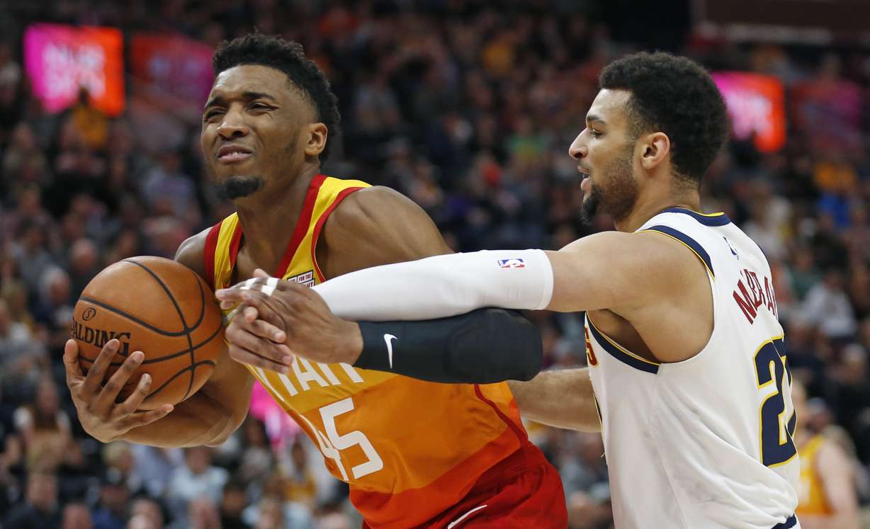 Denver Nuggets guard Jamal Murray, right, defends against Utah Jazz guard Donovan Mitchell (45) in the first half during an NBA basketball game Tuesday, April 9, 2019, in Salt Lake City. (Rick Bowmer, AP Photo)