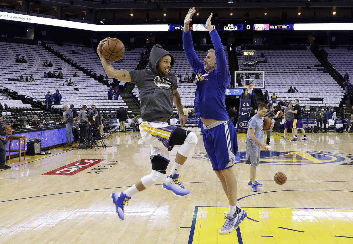 Golden State Warriors assistant coach Bruce Fraser, right, works with guard Stephen Curry during warmups before the team's NBA basketball game against the Los Angeles Lakers on Wednesday, April 12, 2017, in Oakland, Calif. (AP Photo/Marcio Jose Sanchez, File)